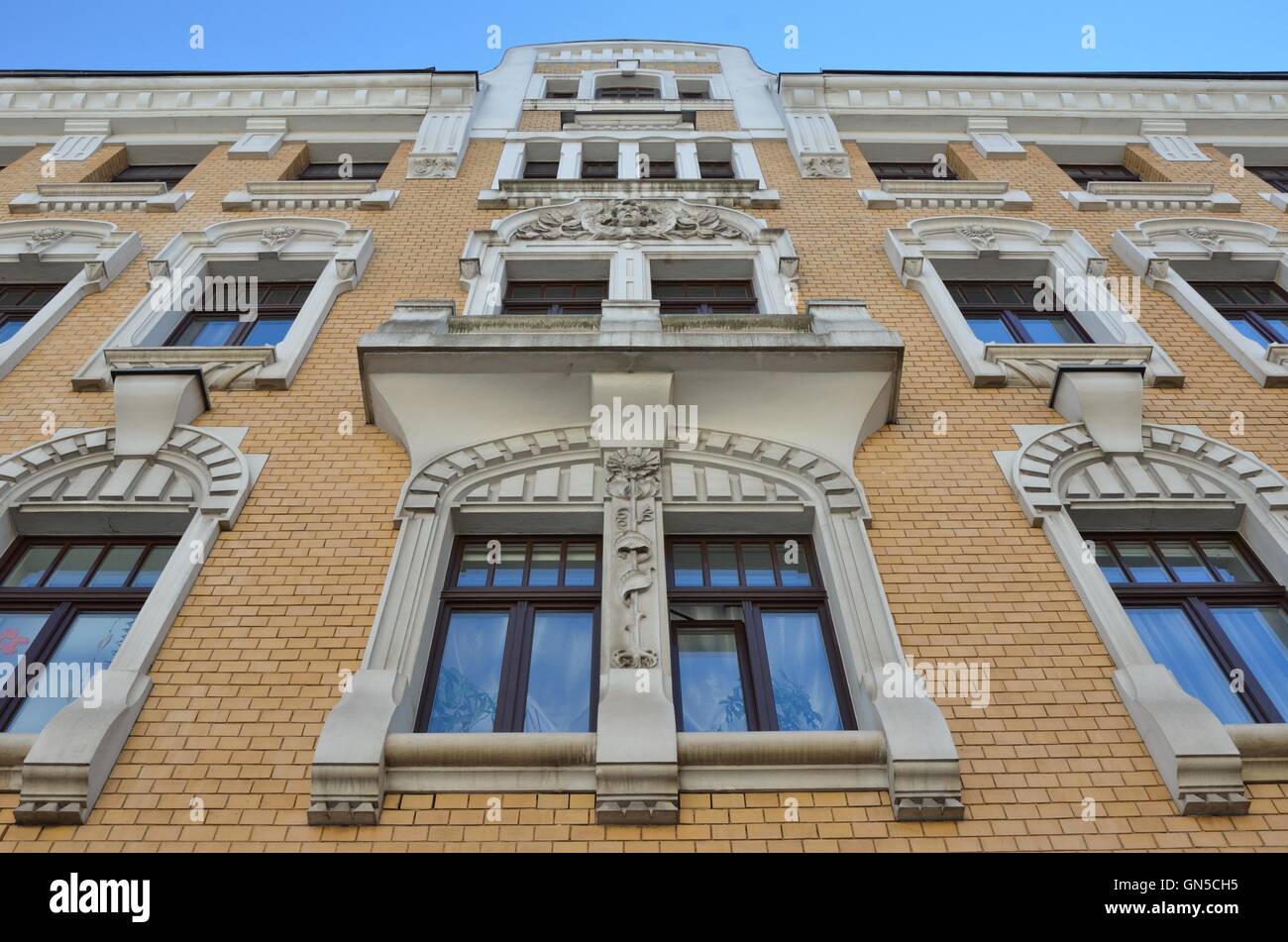 window with white decoration yellow brick building Stock Photo - Alamy