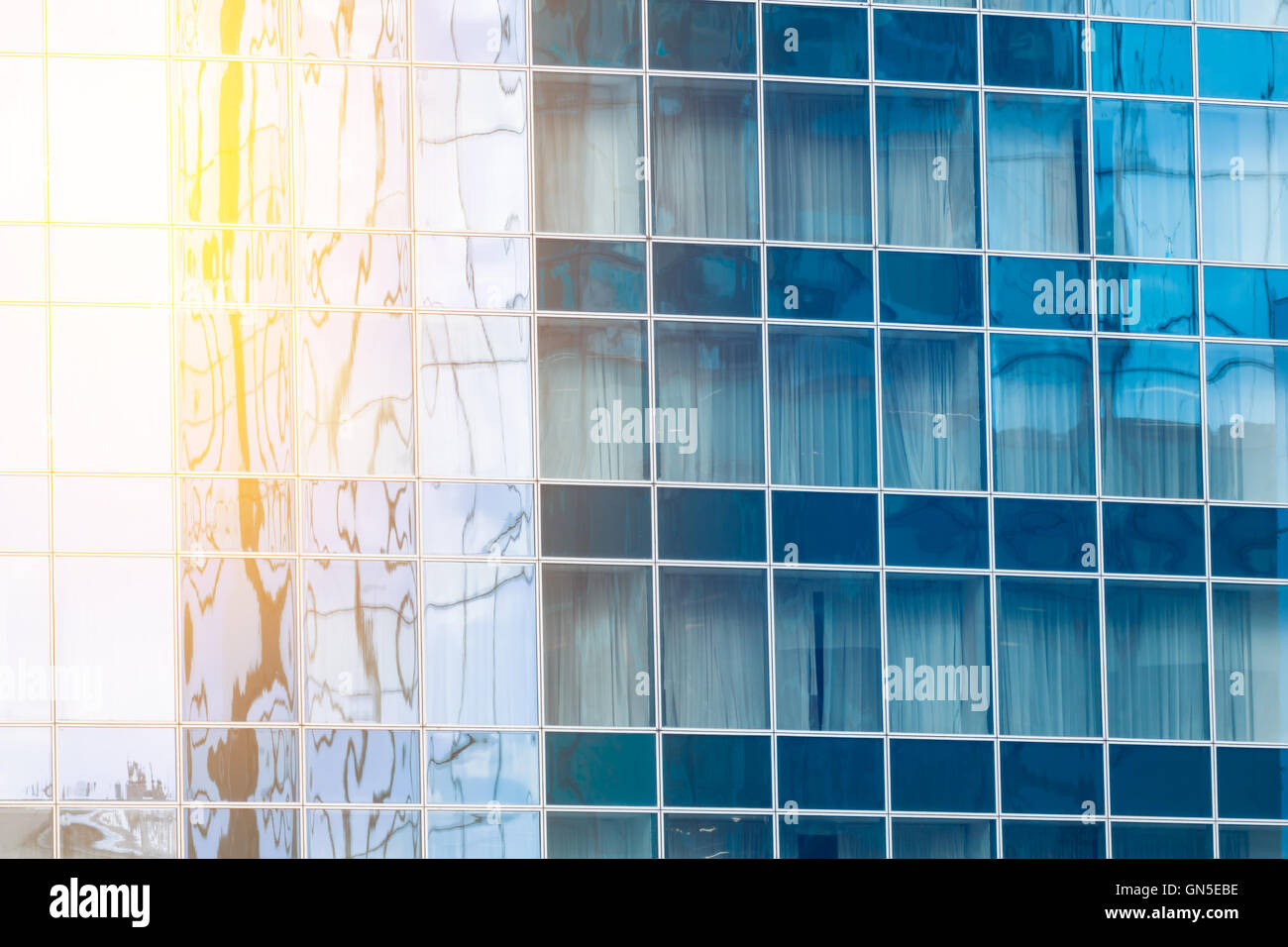 Fragment of the glass facade in the business building with sunflare effect Stock Photo