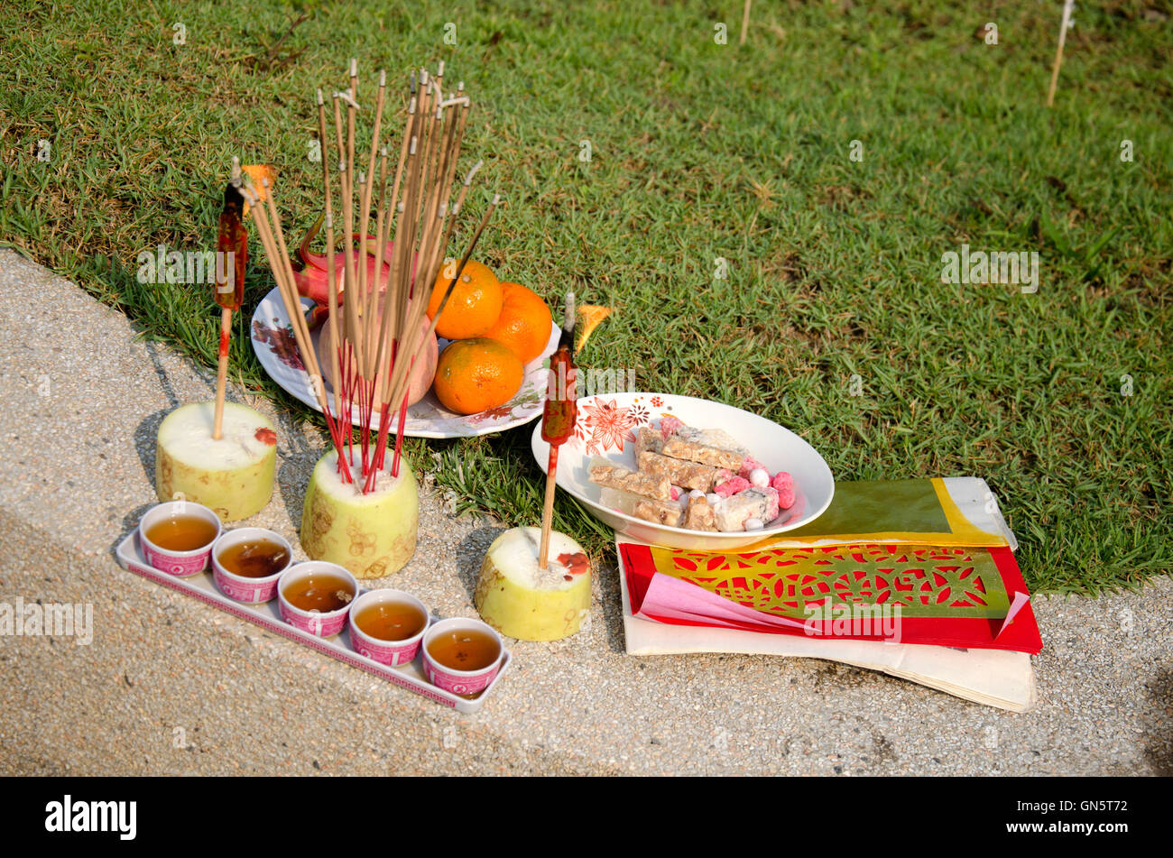 My family praying and sacrificial offering food and joss paper to