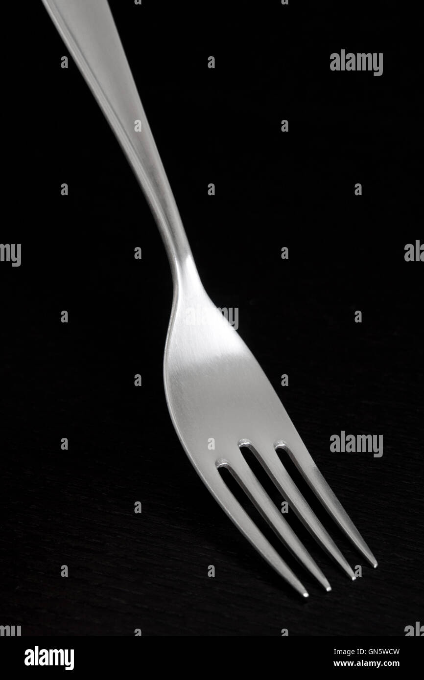 Silver fork on dark background Stock Photo Alamy