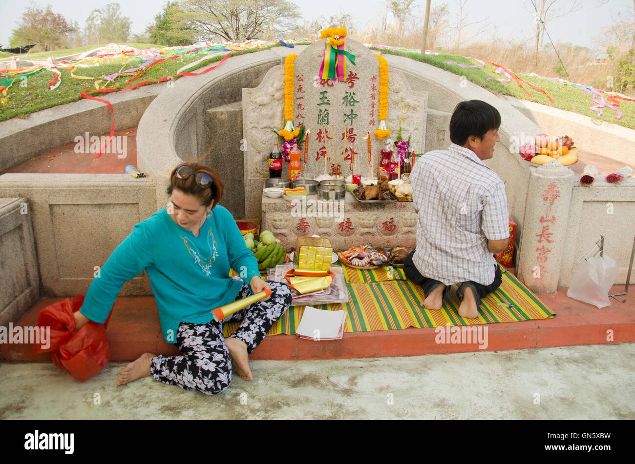 My family praying and sacrificial offering food and joss paper to