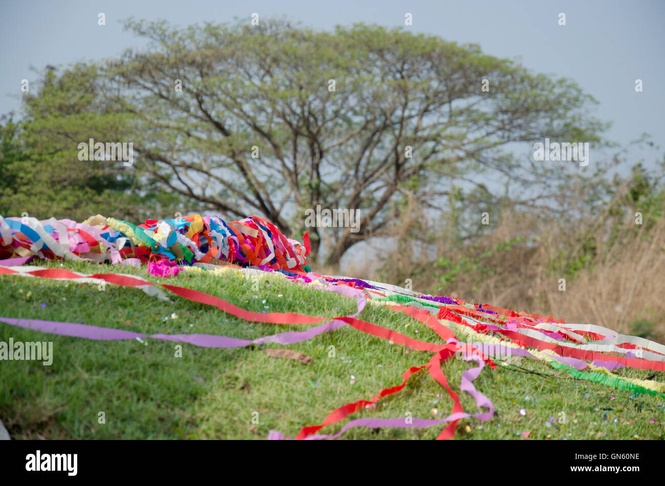 Chinese tradition and culture process colored paper put on a grave of ceremony in Qingming Festival at Sritasala Cemetery in Rat Stock Photo