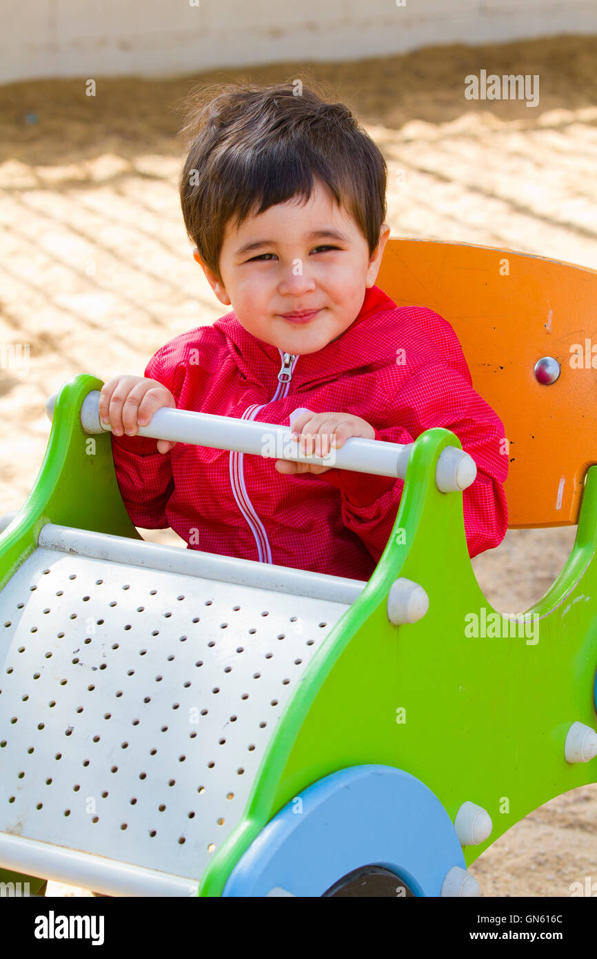 Baby boy playing at park with little car Stock Photo