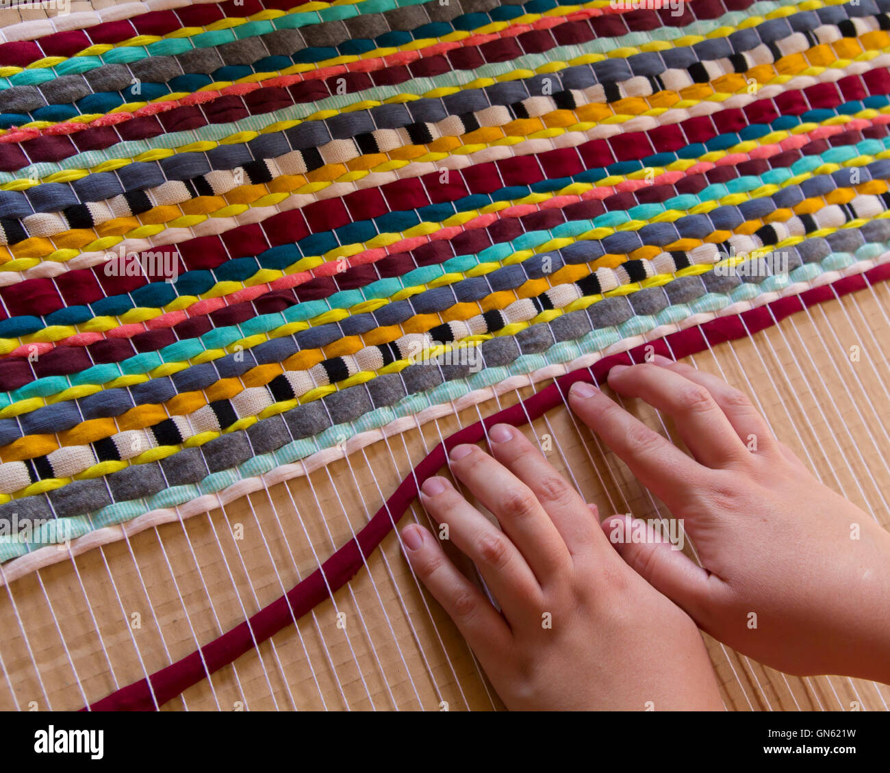 Woman hands weaving a handmade carpet Stock Photo Alamy