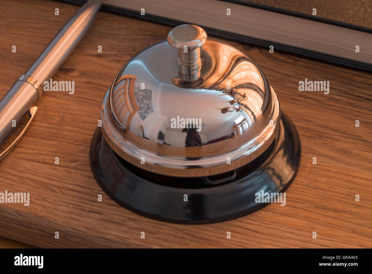 Hotel reception desk with a chrome service bell Stock Photo