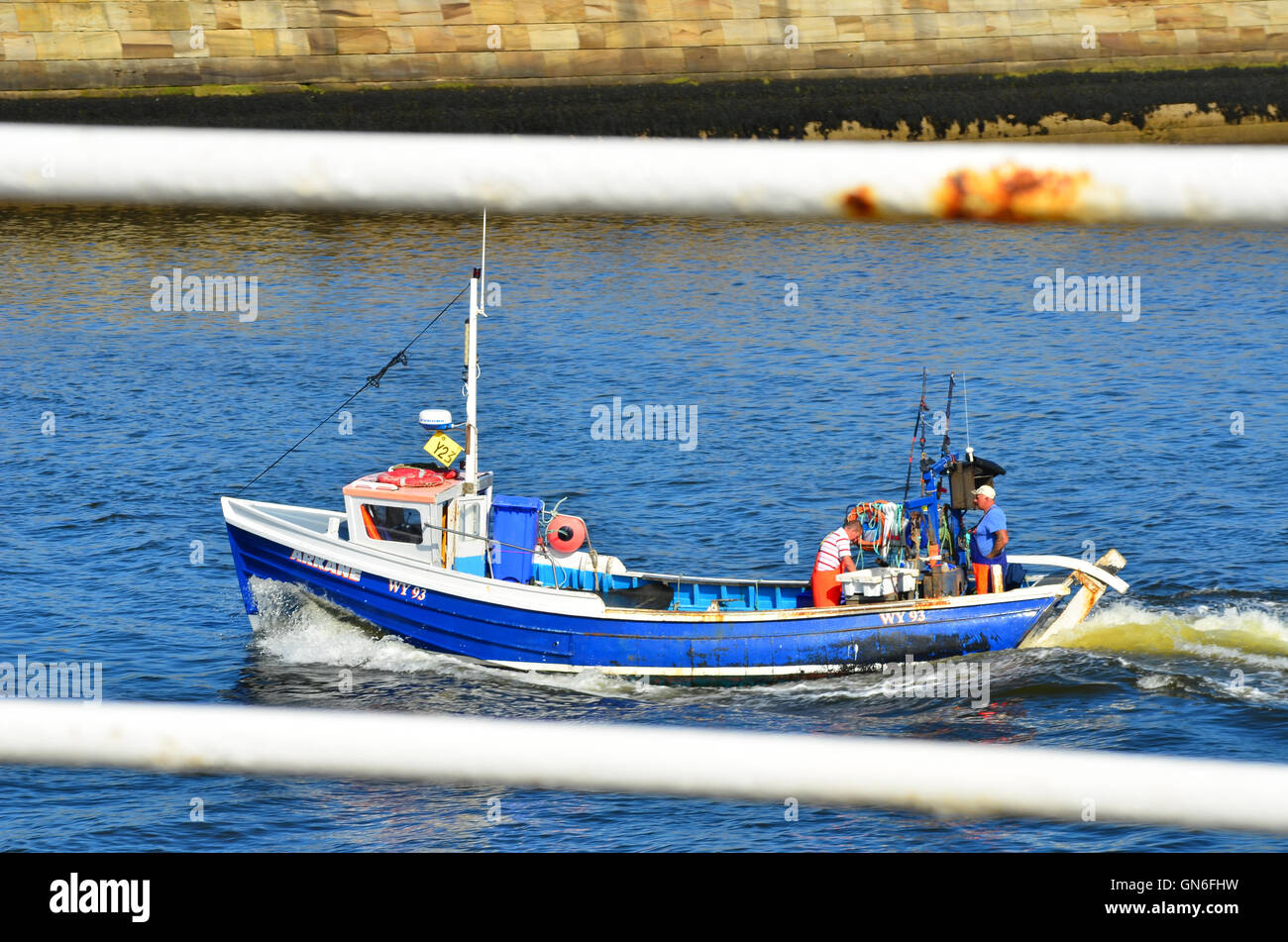 Boat leaving Whitby harbour North Yorkshire England UK Stock Photo - Alamy