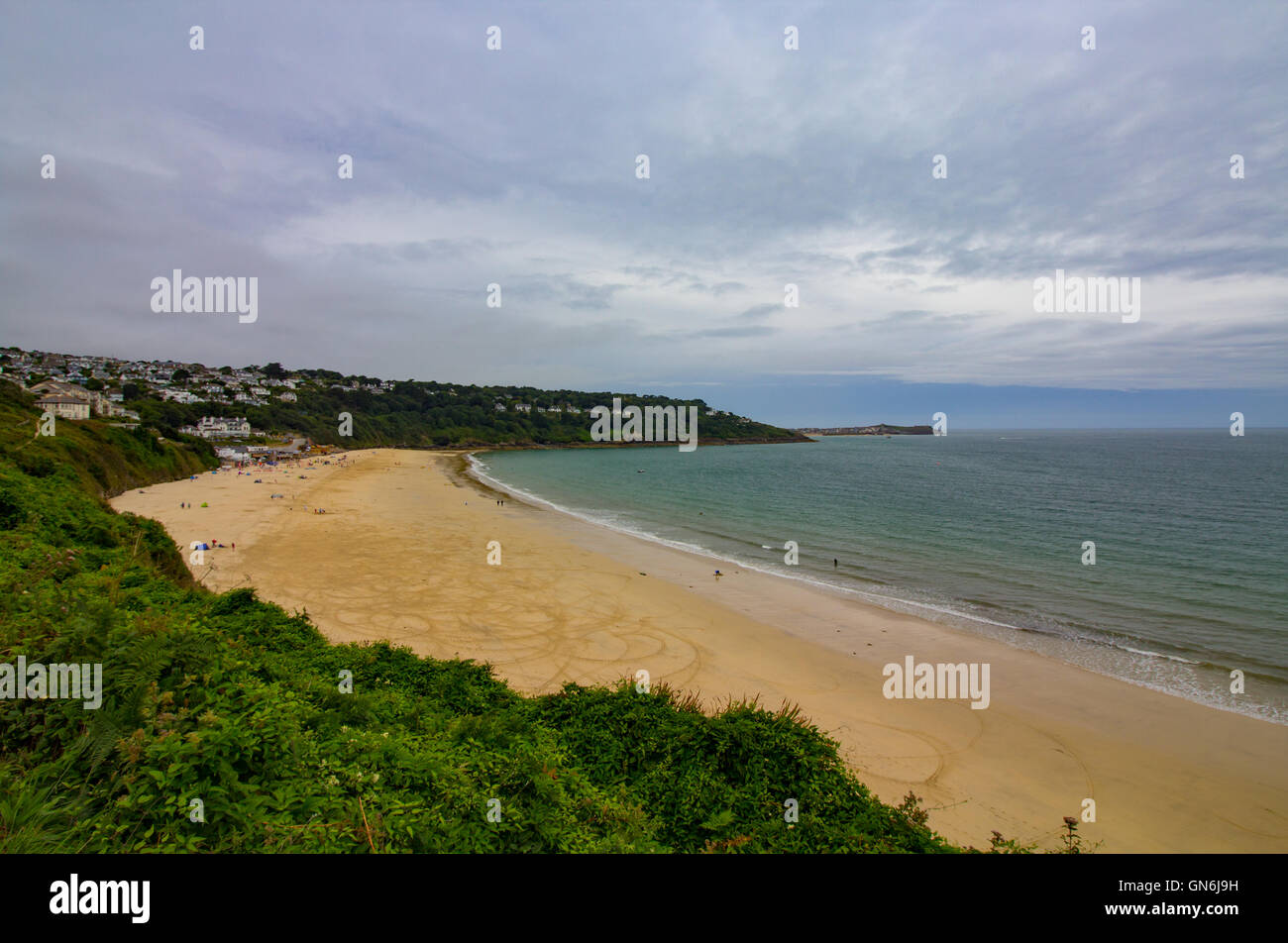 The golden sands at Carbis Bay, Cornwall captured on a moody summers day in the UK. Stock Photo