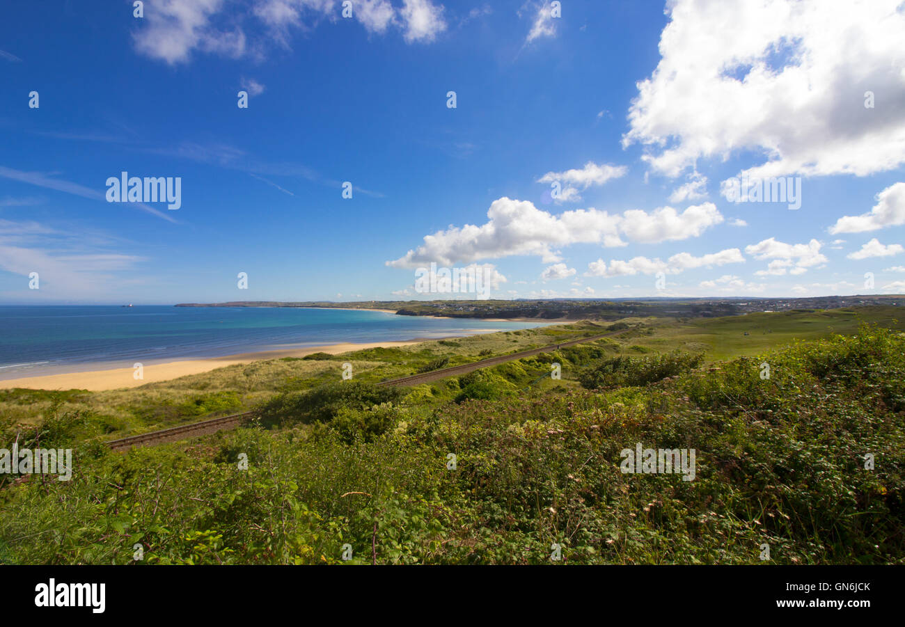 The St Ives Bay train line pictured at Porth Kidney Beach, Lelant, Cornwall, UK Stock Photo