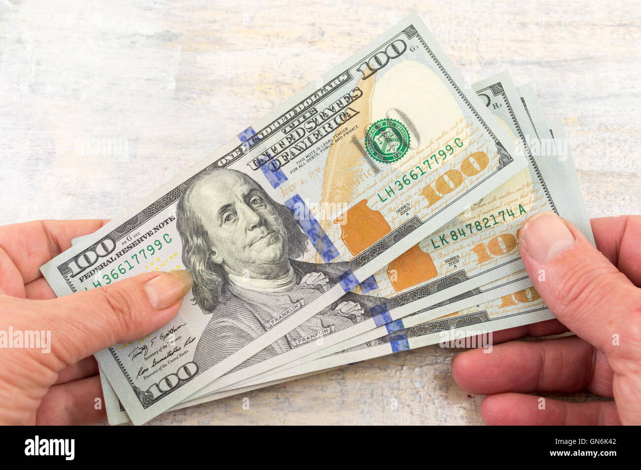 male and female hands holding dollars Stock Photo