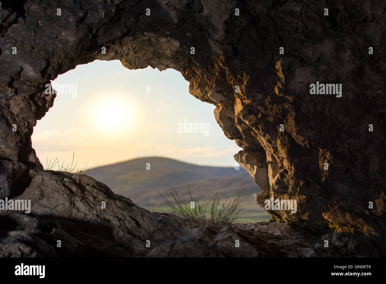 looking thru a natual cave opening Stock Photo