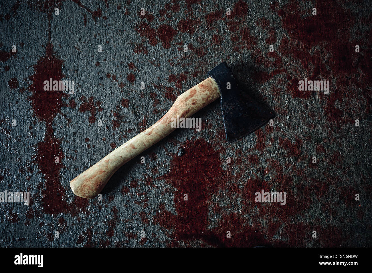 Bloody ax lying on the floor Stock Photo
