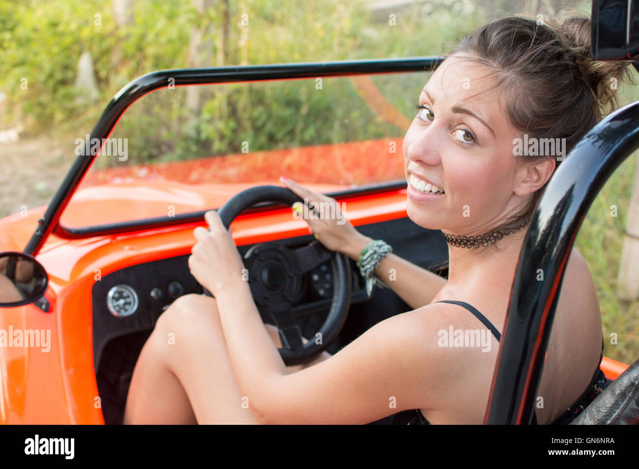 Woman driving a convertible orange sport car Stock Photo