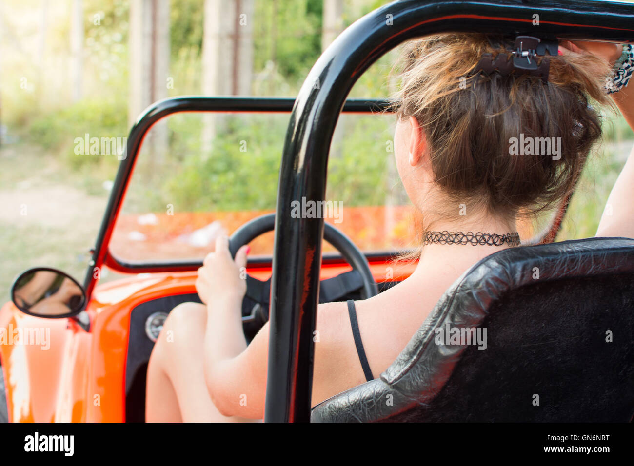 Woman driving a convertible orange sport car Stock Photo