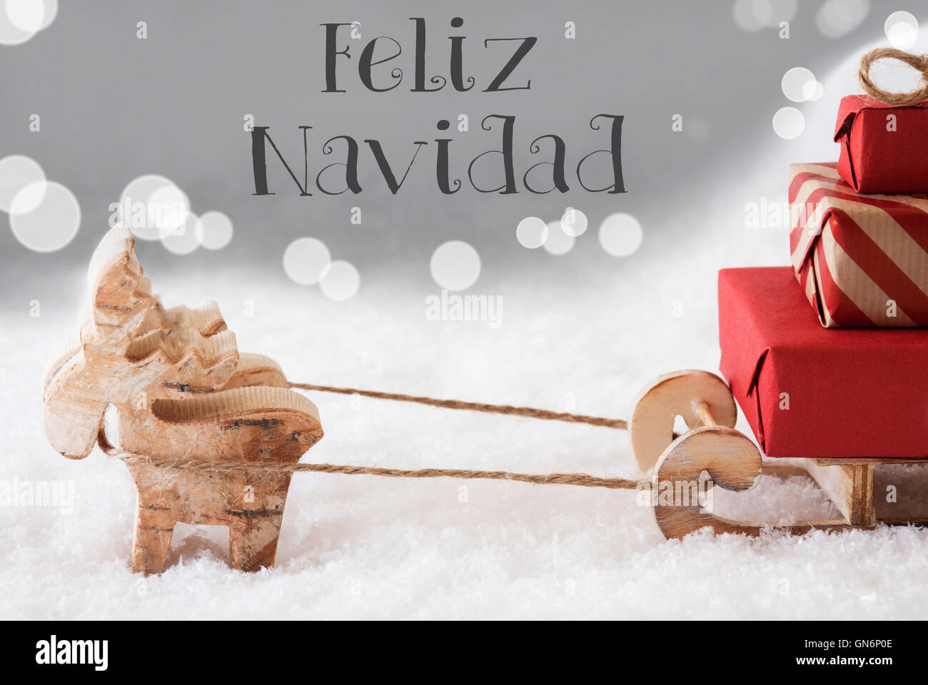 Reindeer With Sled, Silver Background, Feliz Navidad Means Merry Christmas Stock Photo