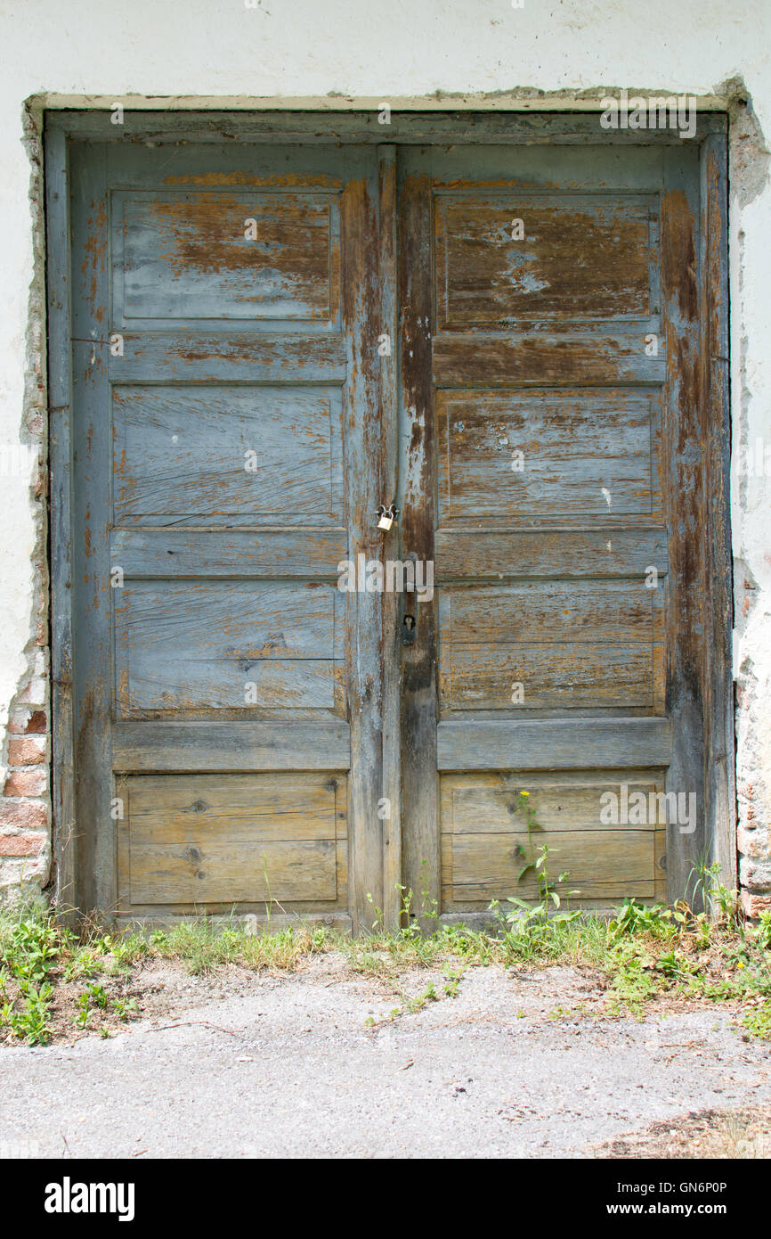 Old wooden house doors on retro wall Stock Photo