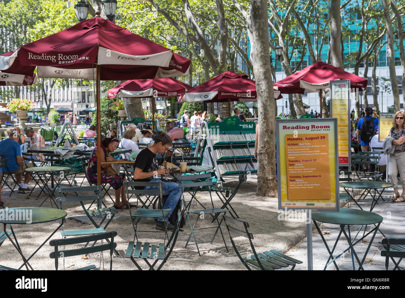 People sit and read books in the Bryant Park Reading Room in New York City. Stock Photo