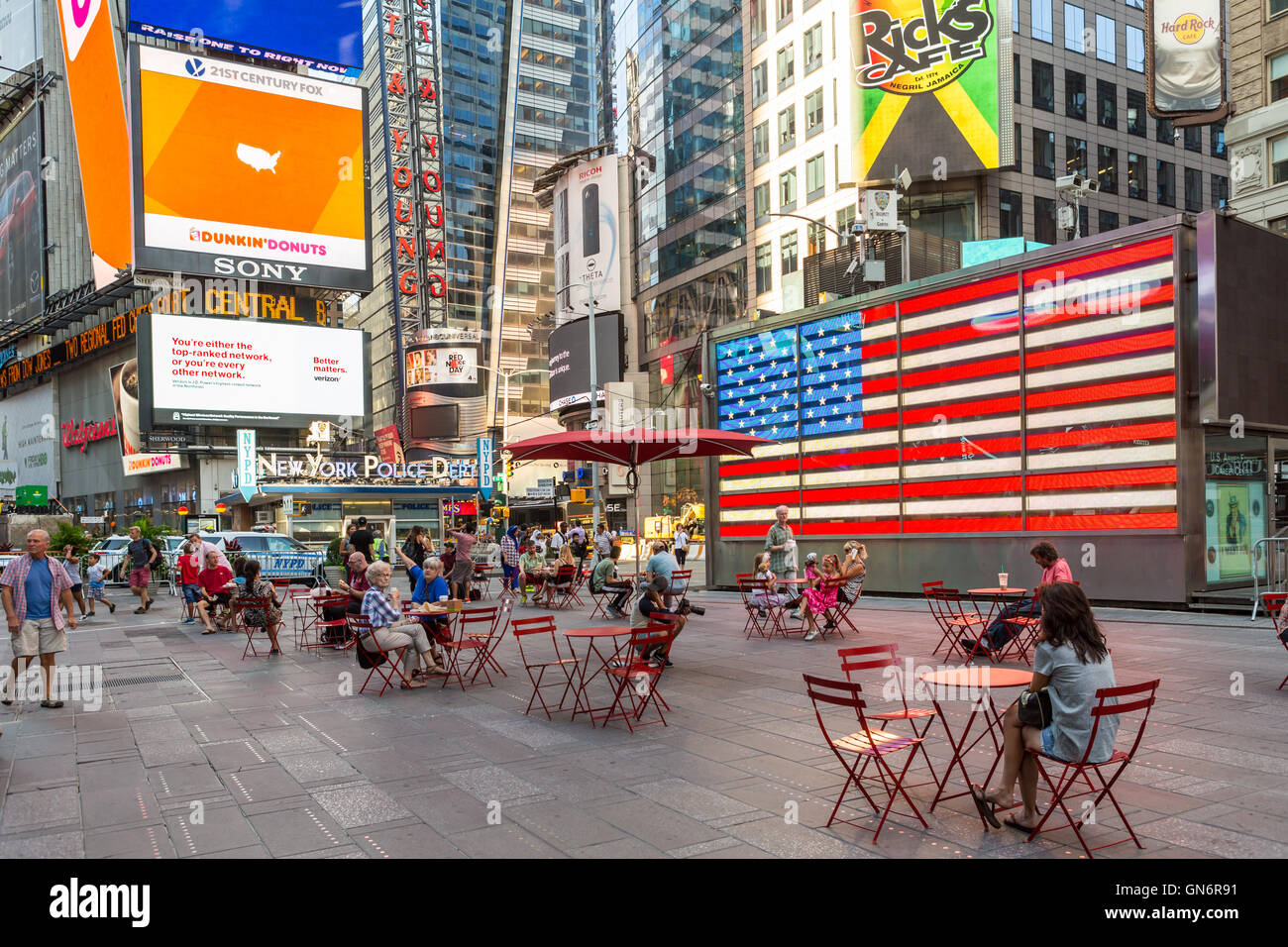 People enjoy the seating in the pedestrian plazas in Times Square  early on a weekend morning in New York City. Stock Photo
