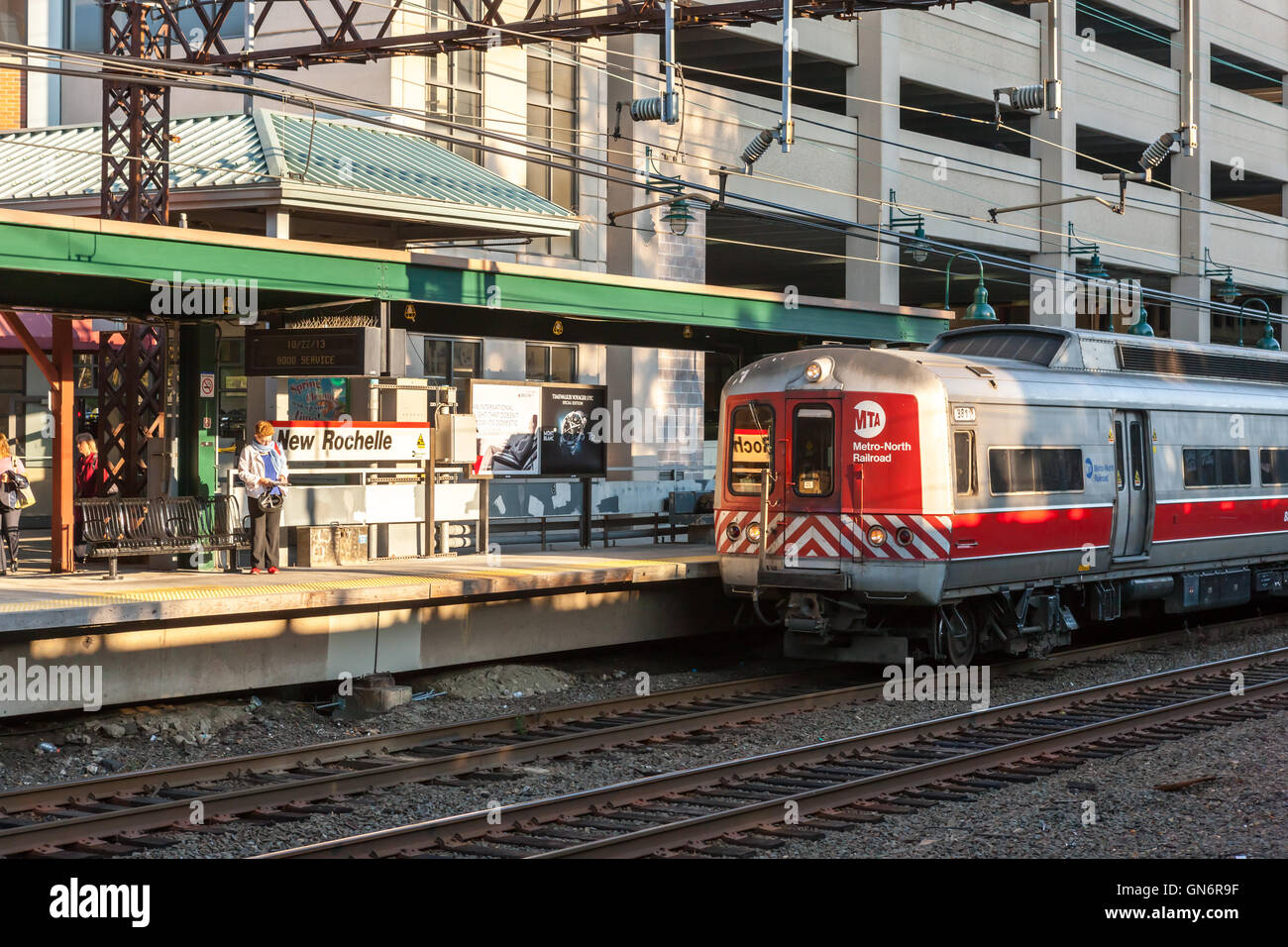 A southbound Metro-North New Haven line commuter train arrives in New Rochelle Station during the morning rush hour. Stock Photo