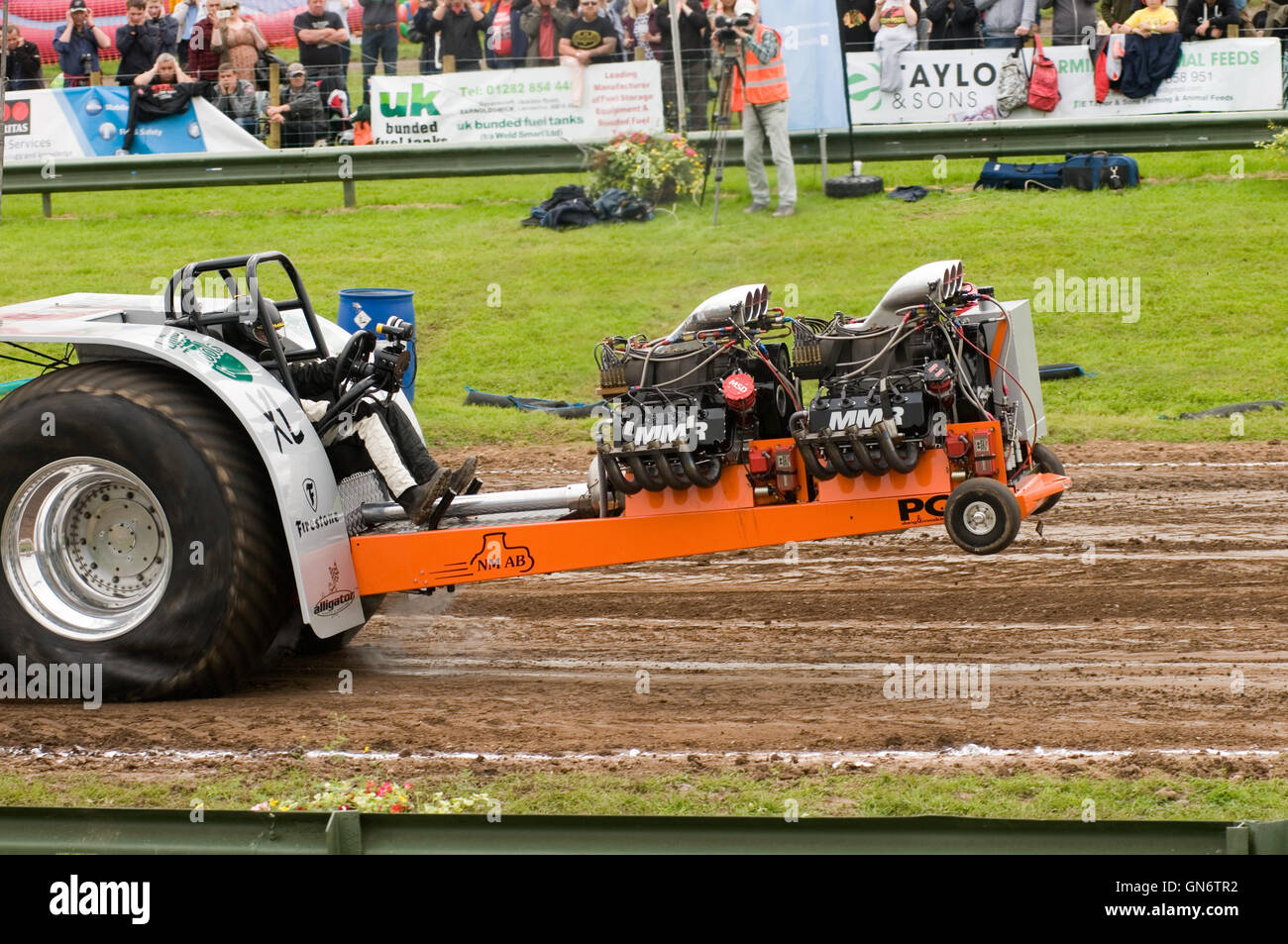 2.5 ton modified tractor pulling a sled while competing in a tractor pull Stock Photo