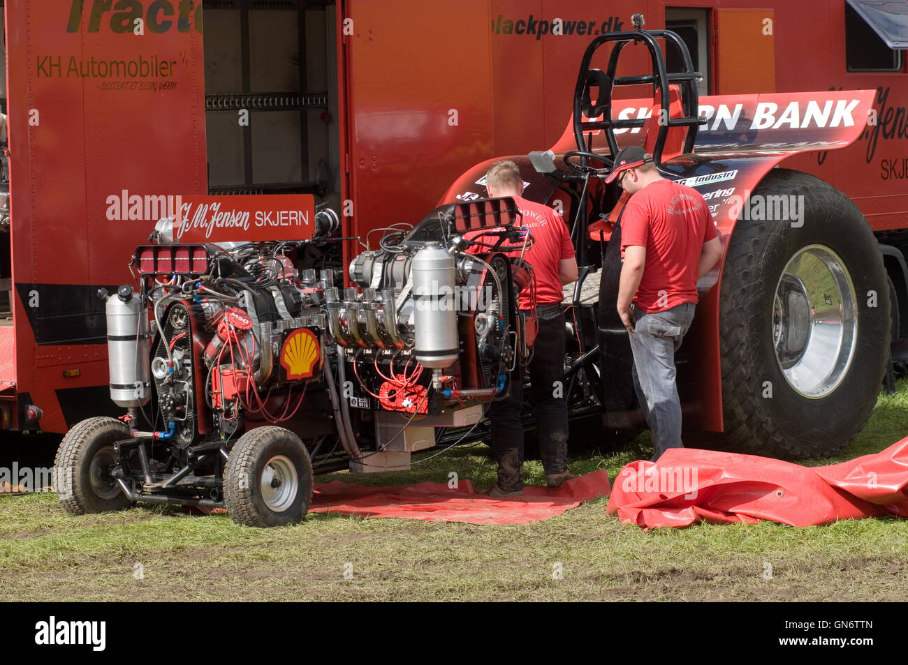 mechanic working on a modified tractor at a tractor pull Stock Photo