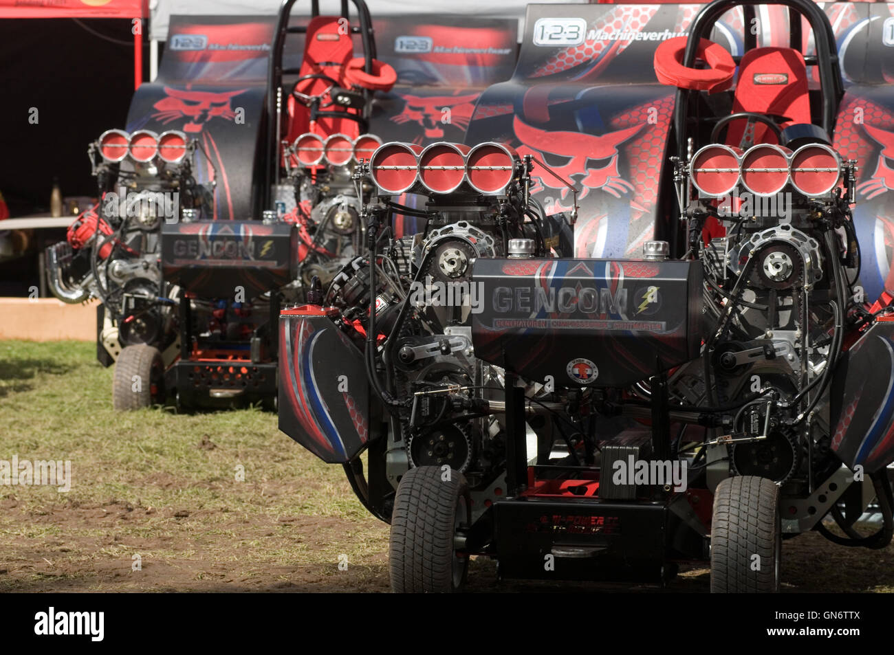 modified tractor pullers in the the pits before competing in a tractor pull Stock Photo