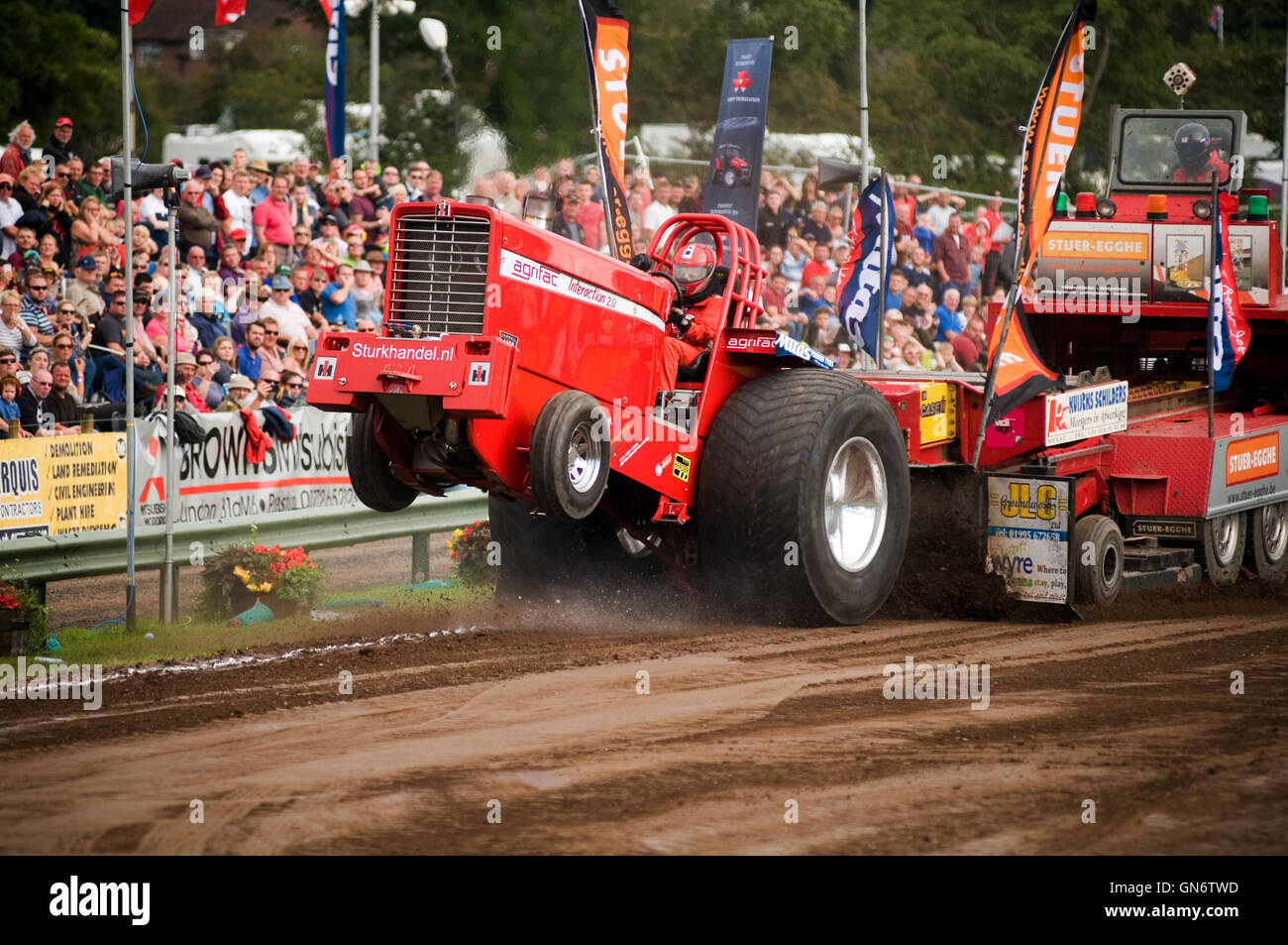 Super Stock tractor puller goes out of bounds during a pull Stock Photo