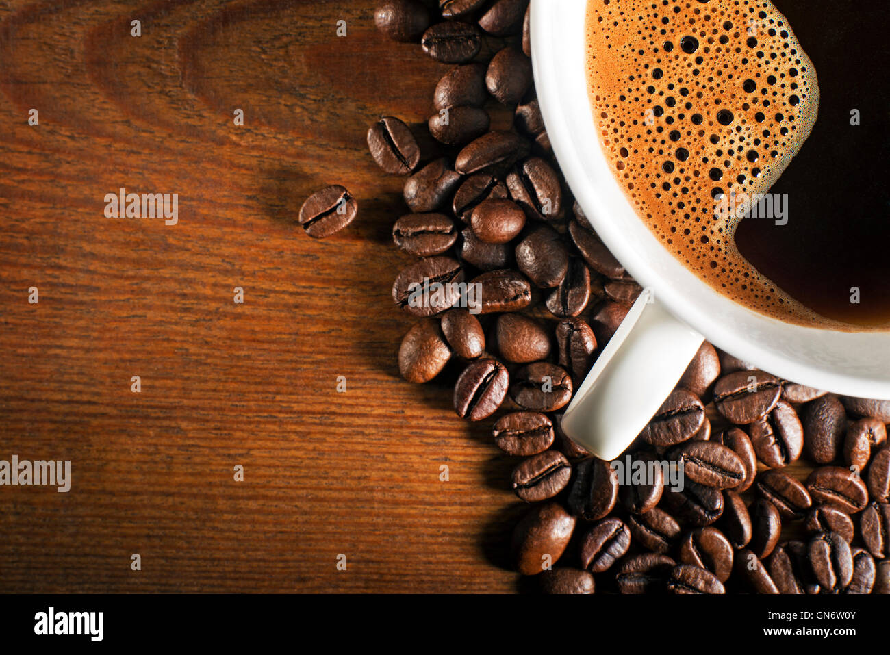 https://c8.alamy.com/comp/GN6W0Y/coffee-cup-and-beans-on-a-wooden-background-GN6W0Y.jpg