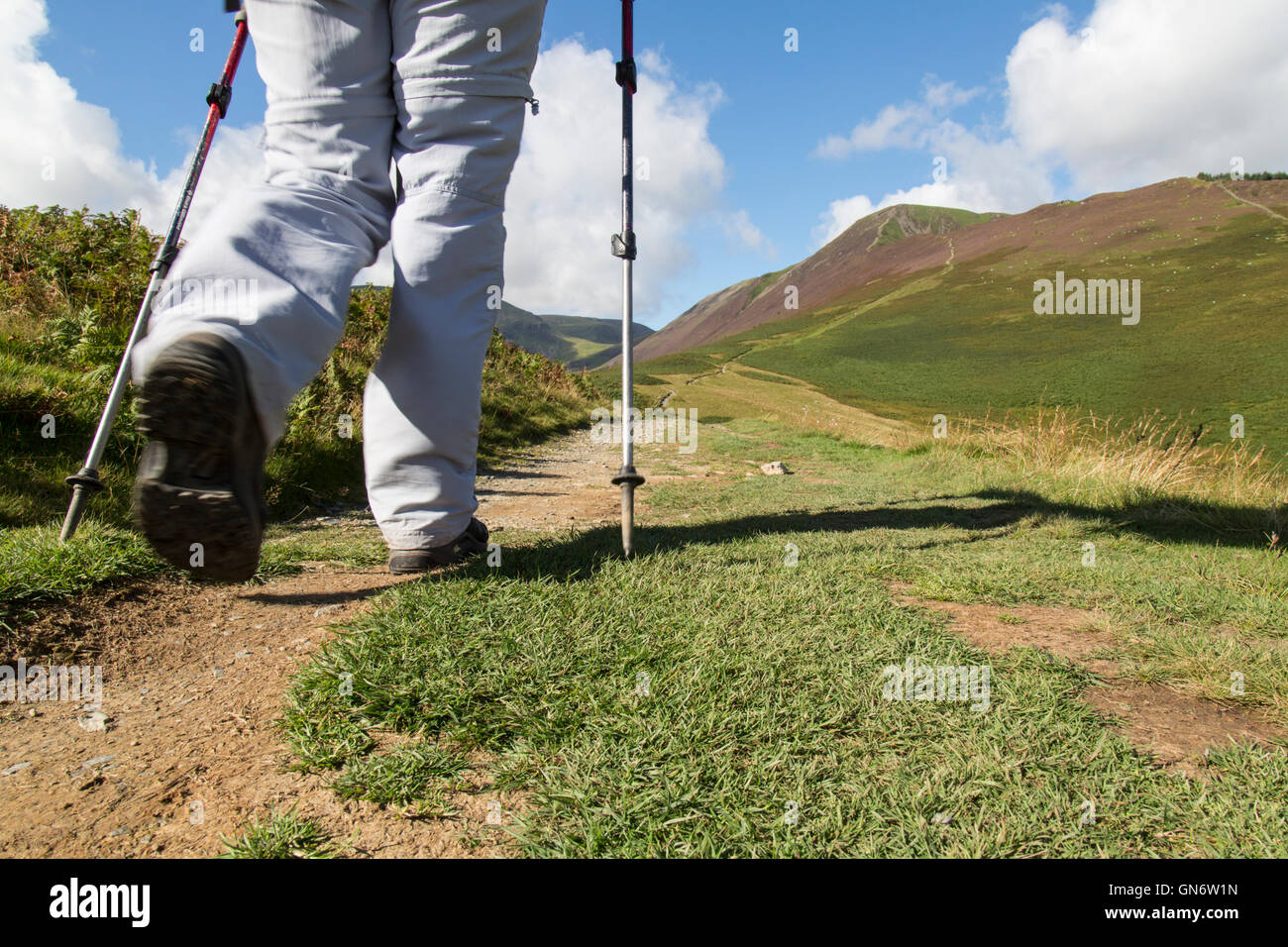 View of legs of a female hiker heading towards Grisedale Pike, in the Lake District National Park in Cumbria, England. Stock Photo