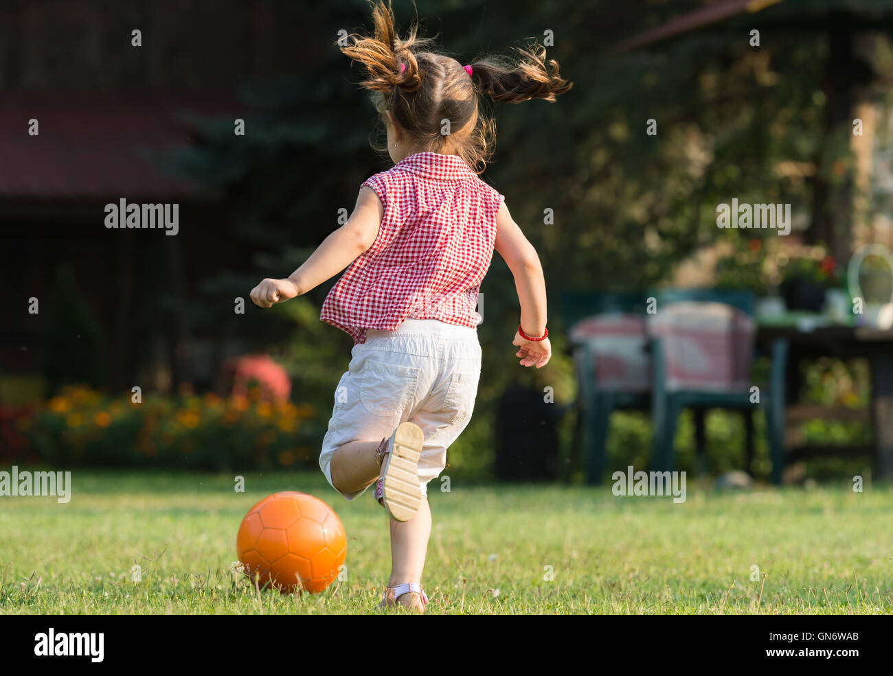 Little girl Shooting at Goal Stock Photo