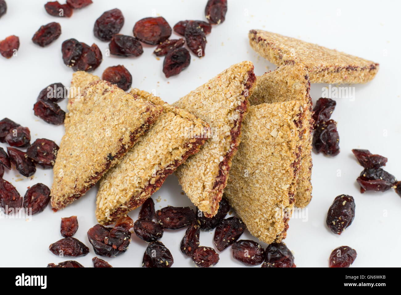 Integral triangle cookies with red raisins on white table Stock Photo