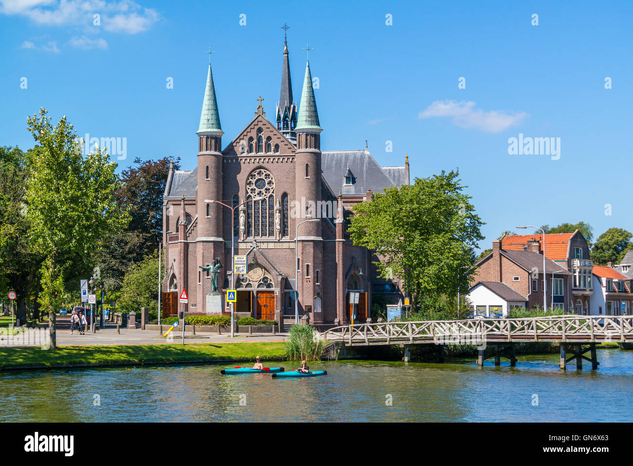 People in kayaks on Singelgracht canal and St. Joseph's Church in Alkmaar, Netherlands Stock Photo