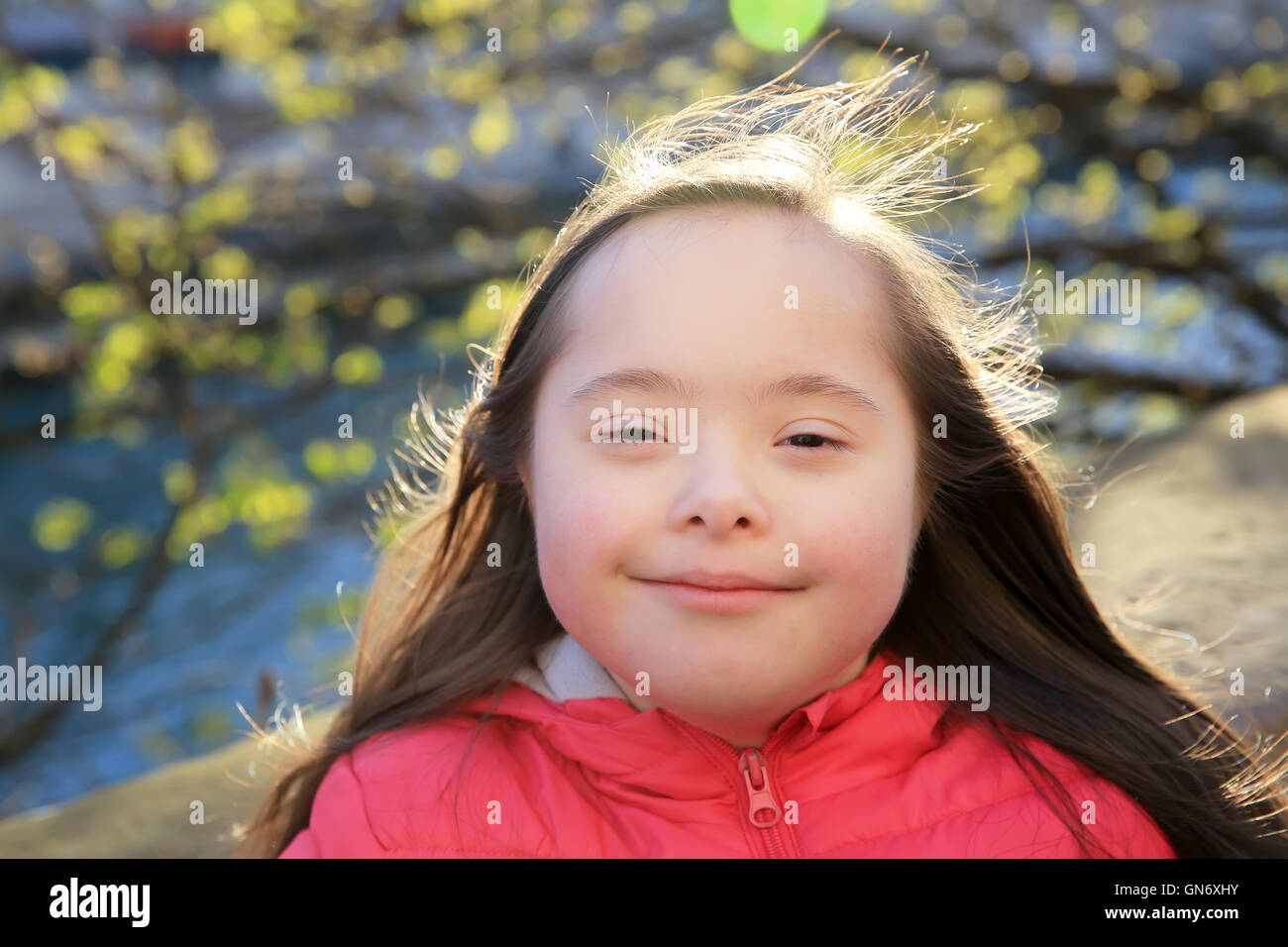 Portrait of little girl smiling outside Stock Photo - Alamy
