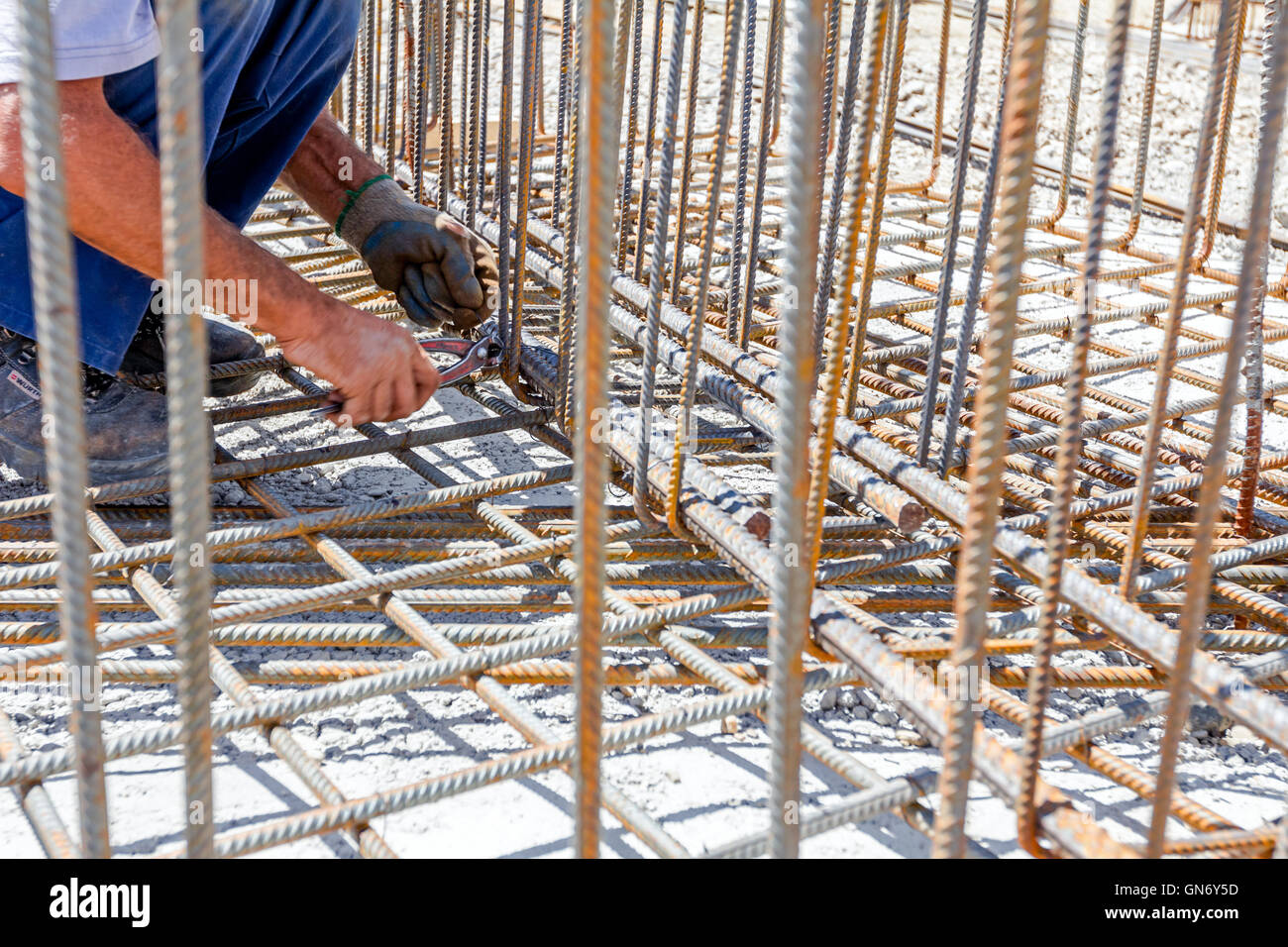 Workers are tying rebar to make a newly constructed footing frame. Binding concrete frame Stock