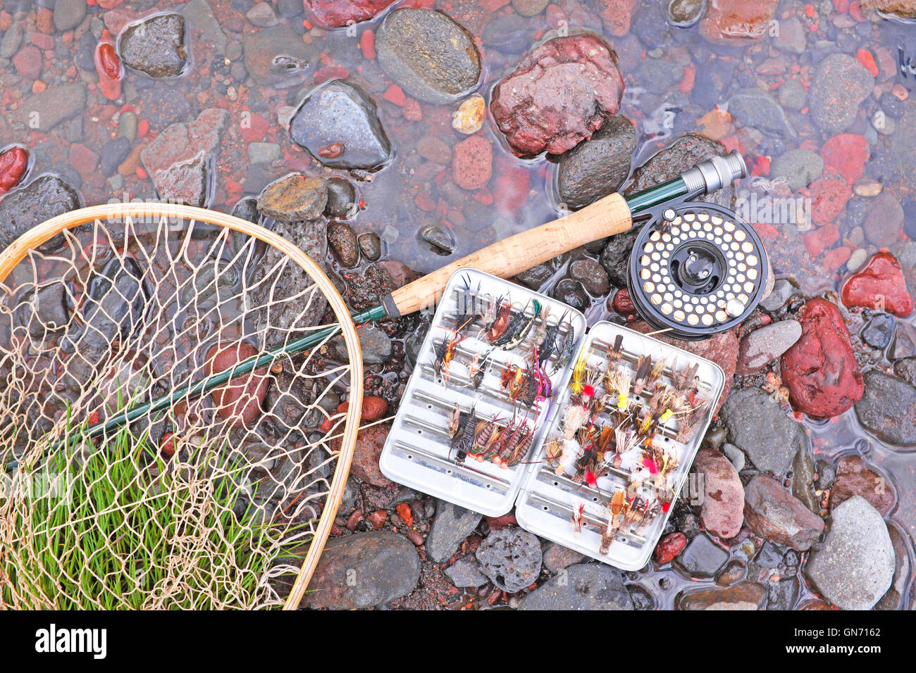 Trout fishing equipment, rod, reel, and artificial flies, on a small creek in Oregon. Stock Photo
