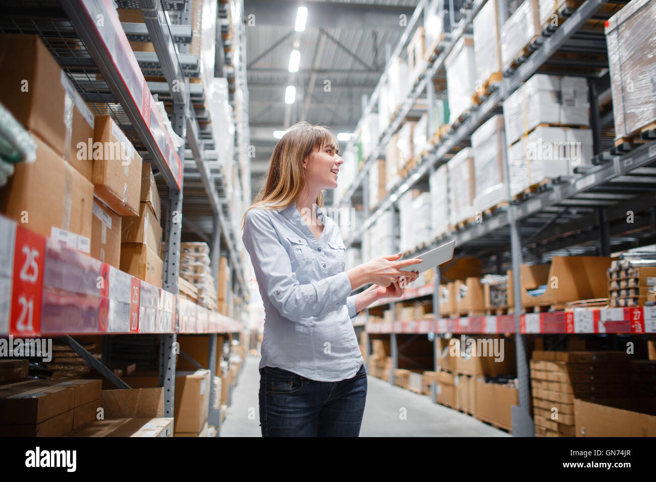 beautiful young furniture store store worker stock taking Stock Photo