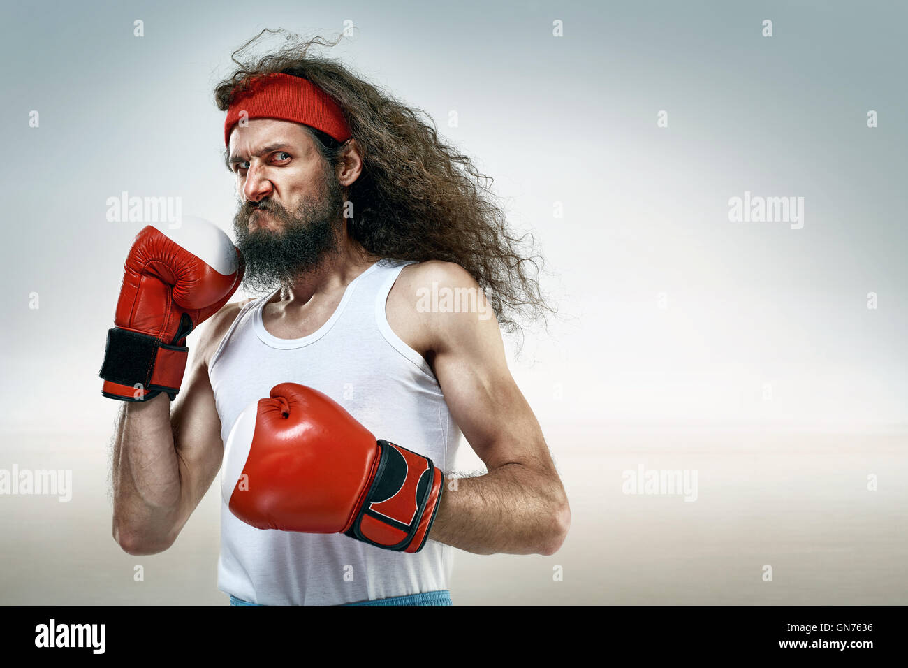 Skinny boxer wearing red boxing gloves Stock Photo Alamy