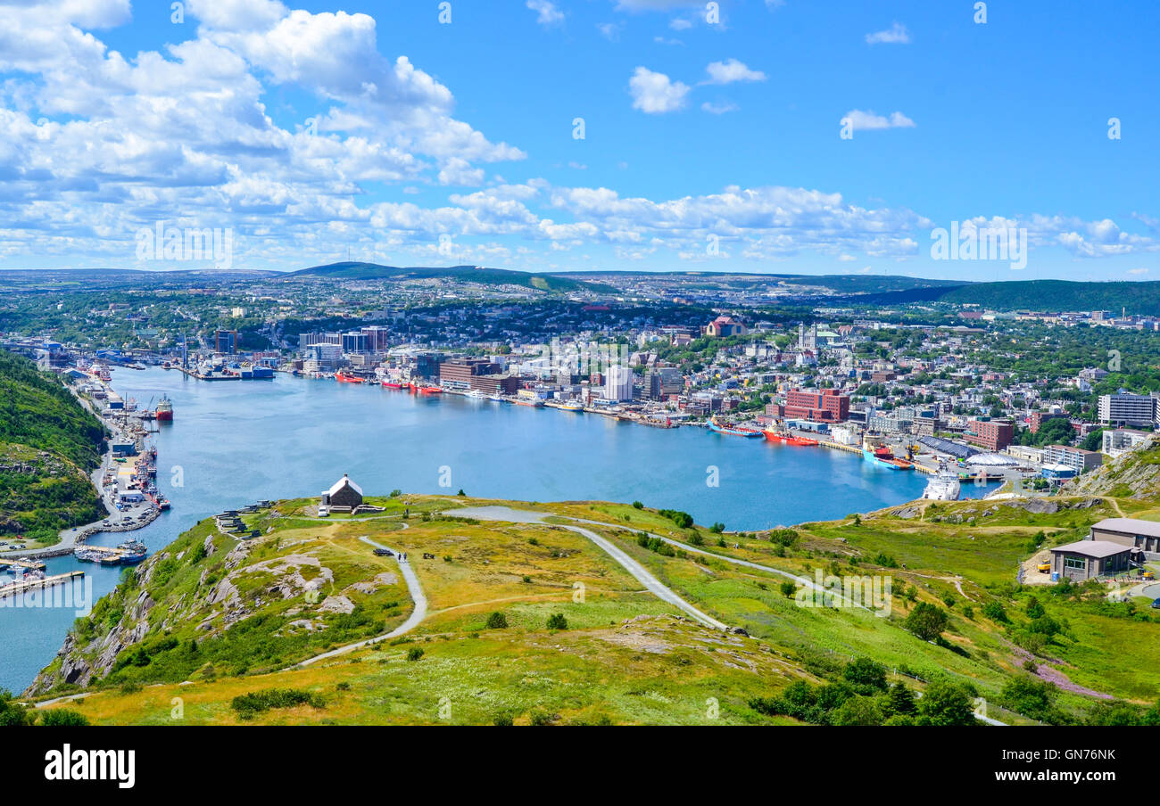 Panoramic views with bight blue summer day sky with puffy clouds over the harbor and city of St. John's Newfoundland, Canada. Stock Photo