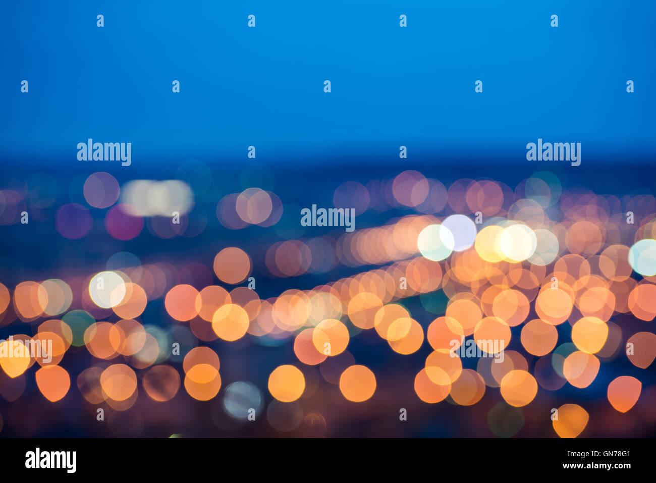 abstract circular bokeh background, city lights in the twilight with horizon, closeup Stock Photo