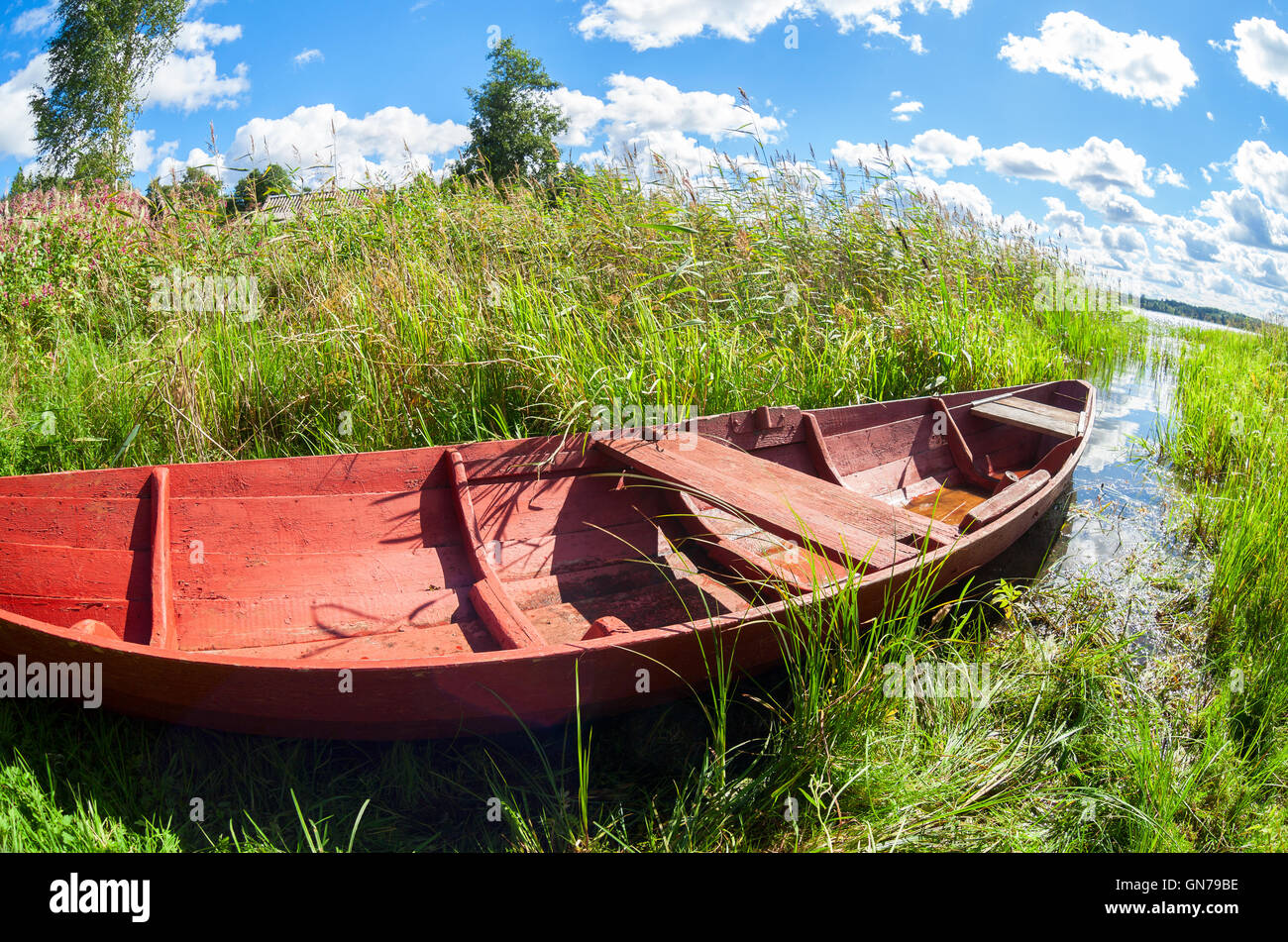 Old wooden fishing boat at the lake in summer day Stock Photo - Alamy