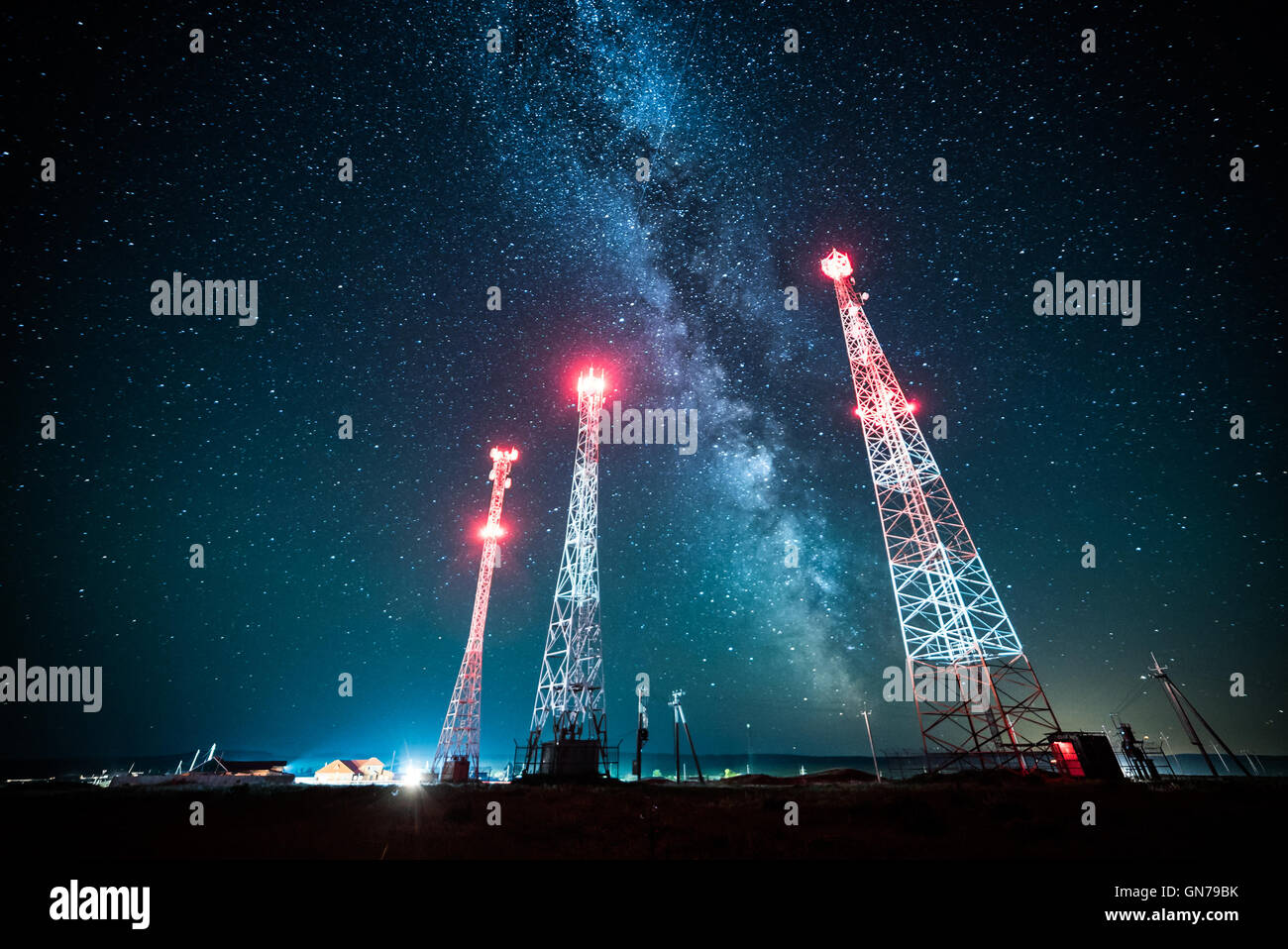 Power lines against night sky and milky way galaxy Stock Photo