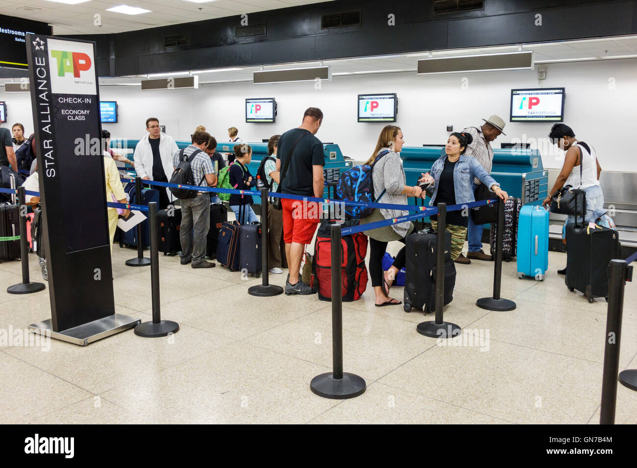 Miami Florida International Airport MIA,aviation,terminal,TAP Portugal Airline Company,Portuguese carrier,ticket counter,agent,job,Black adult,adults, Stock Photo