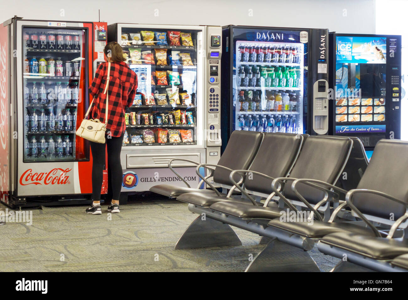 Miami Florida International Airport MIA,aviation,terminal,gate,vending machine,water,soft drink drinks,soda,Coca-Cola,adult adults,woman female women, Stock Photo