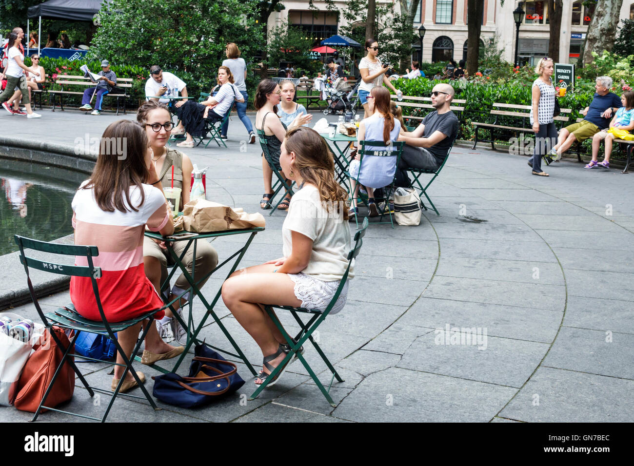 New York City,NY NYC,Manhattan,Madison Square Park,garden,outdoor space,bench,adult adults,woman women female lady,girl girls,youngster youngsters you Stock Photo