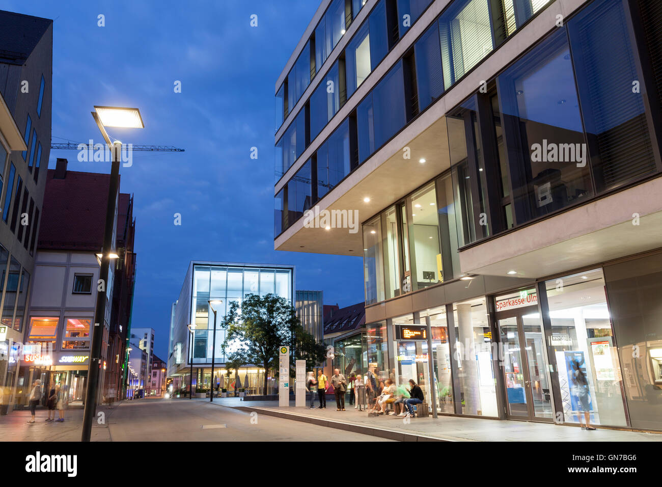 Street in Ulm illuminated at night, Germany Stock Photo