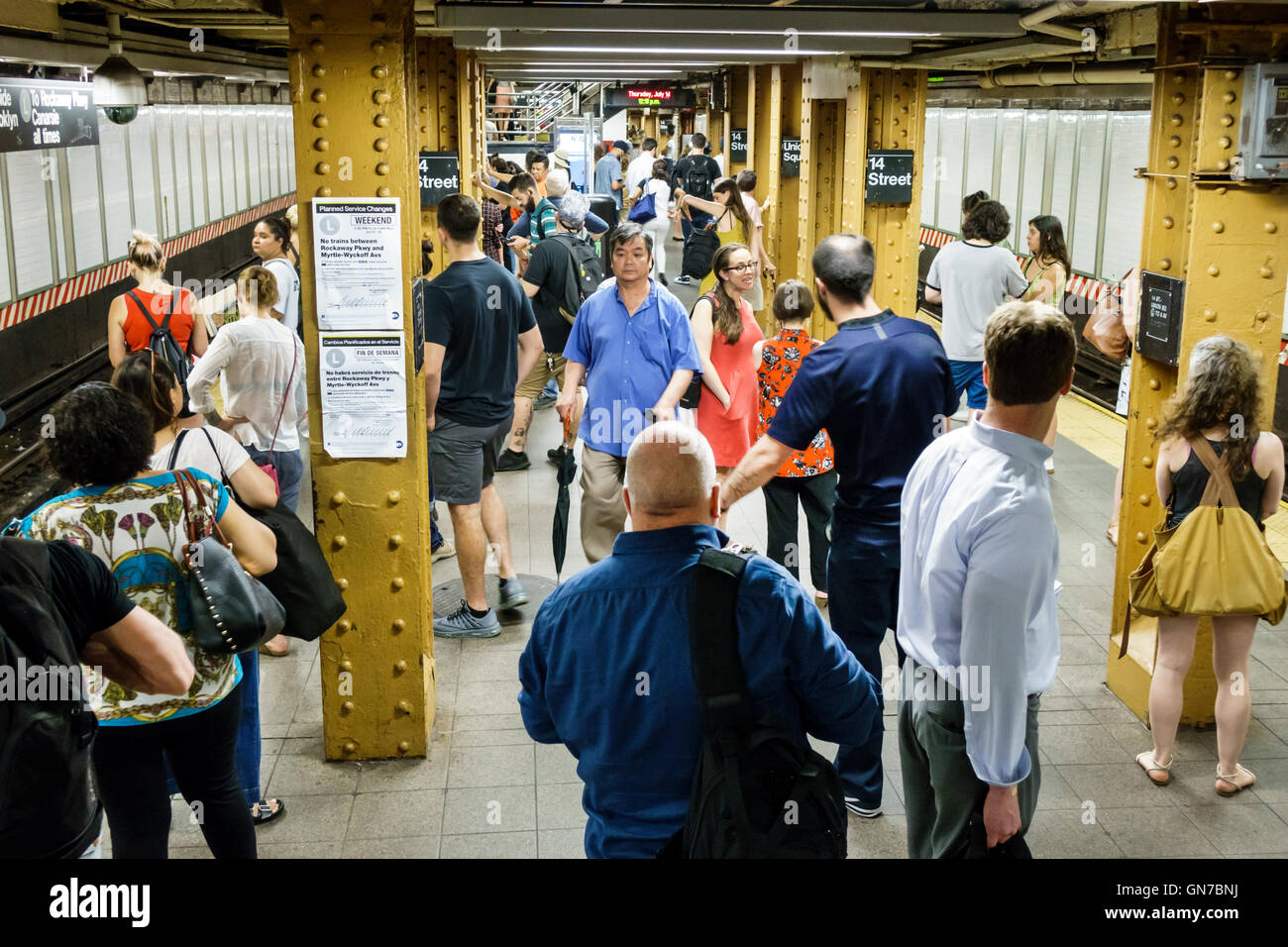New York City,NY NYC Manhattan,Midtown,14th Street-Union Square,subway,station,MTA,platform,crowded,Asian adult,adults,man men male,woman female women Stock Photo