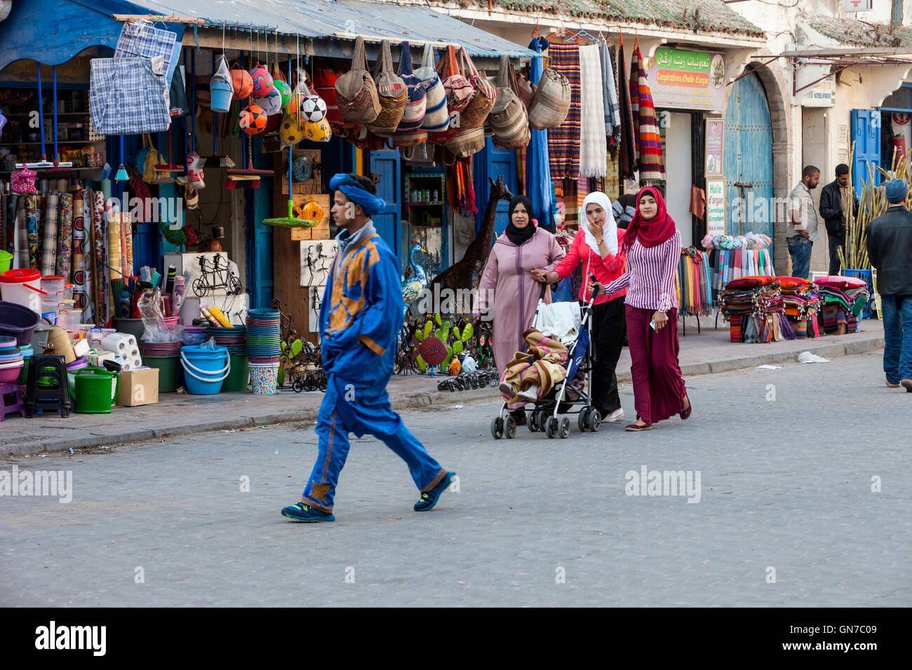 Essaouira, Morocco.  Women and Young Man Walking in Avenue de l'Istiqlal. Stock Photo