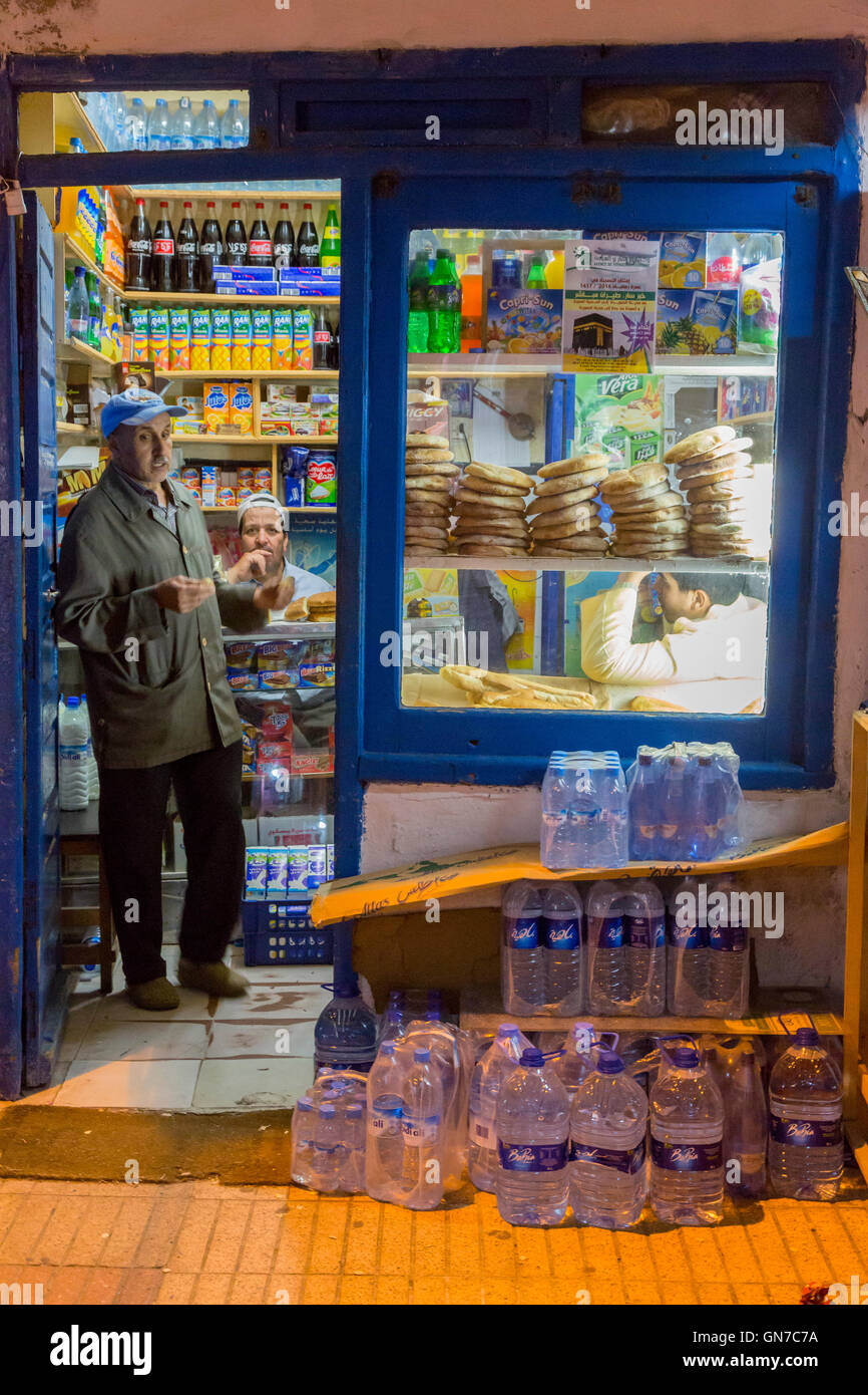 Essaouira, Morocco.  Bread, Water, and Sundries Available at a Small Shop in the Medina, Night Shot. Stock Photo