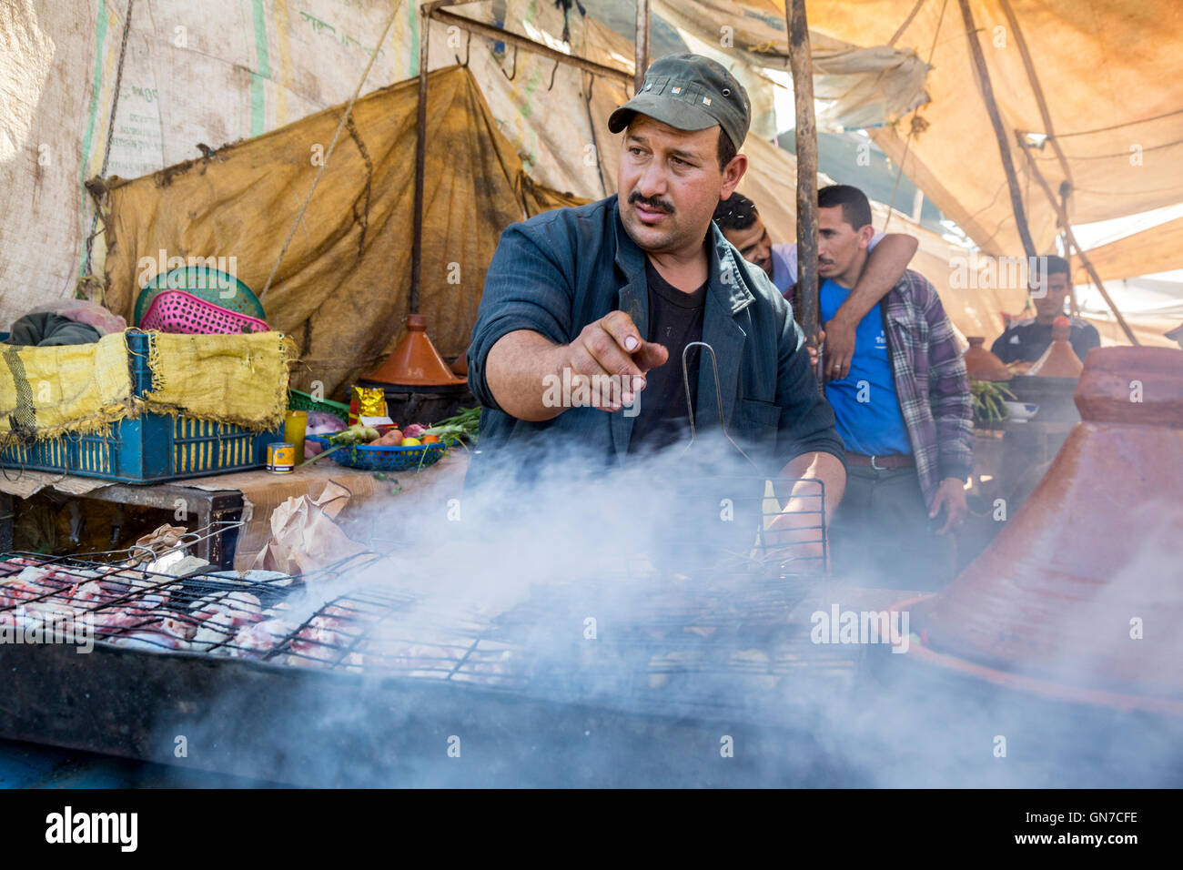 Morocco.  Vendor Grilling Brochettes (Shish-kebabs), Had Draa Market, Essaouira Province. Stock Photo