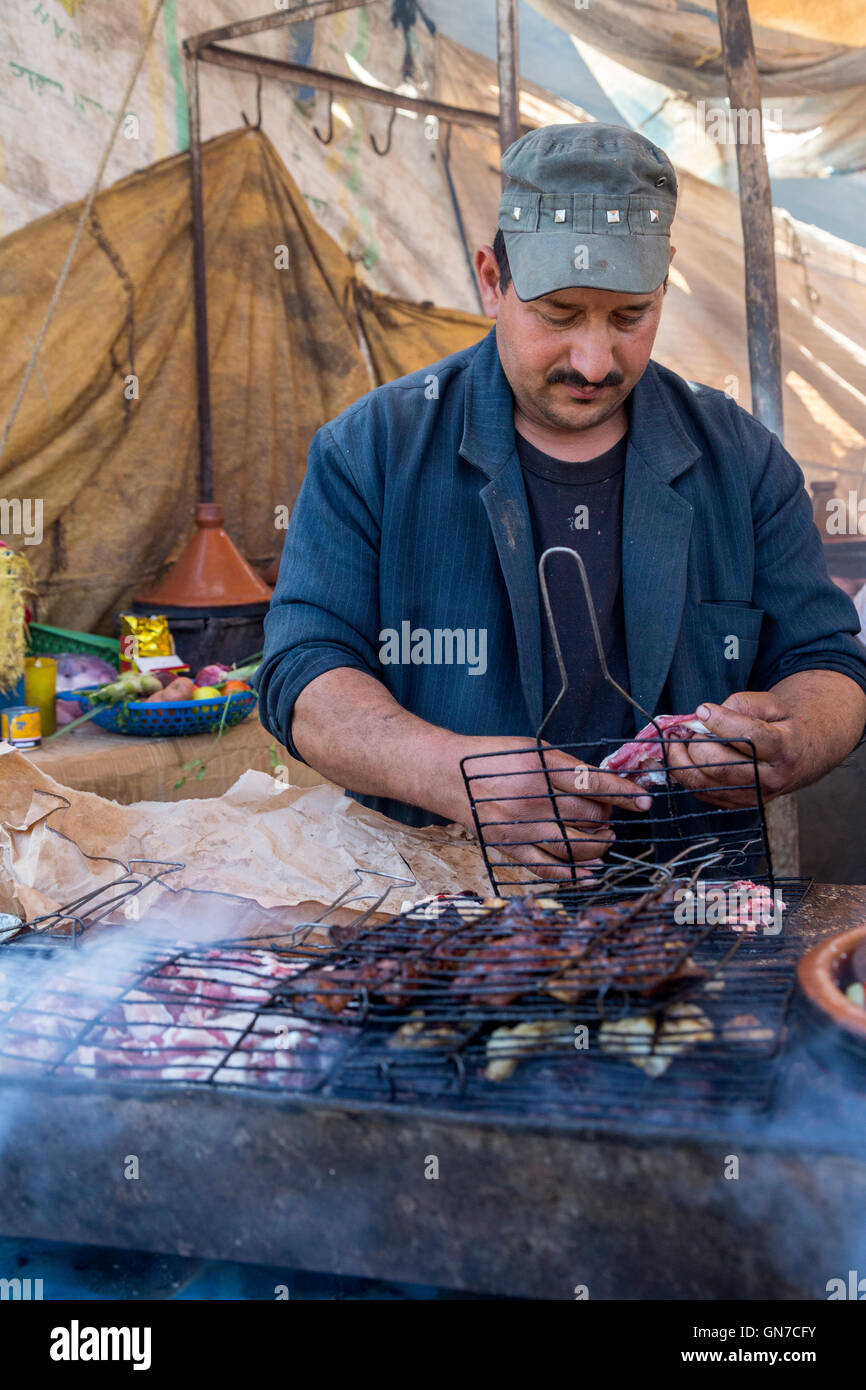 Morocco.  Vendor Grilling Brochettes (Shish-kebabs), Had Draa Market, Essaouira Province. Stock Photo
