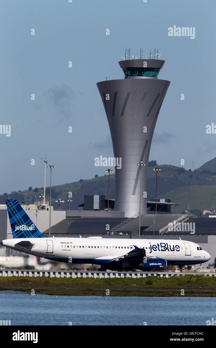 Jet Blue Airbus A320-232 (N606JB) passes the control tower on takeoff at San Francisco International Airport (SFO), Millbrae, California, United States of America Stock Photo